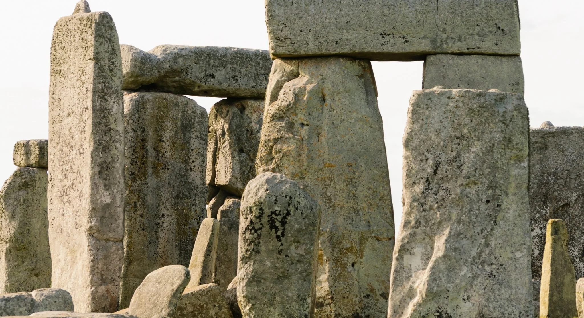 Close-up of ancient stone structures, likely part of a historical monument or site, with weathered surfaces and irregular shapes.