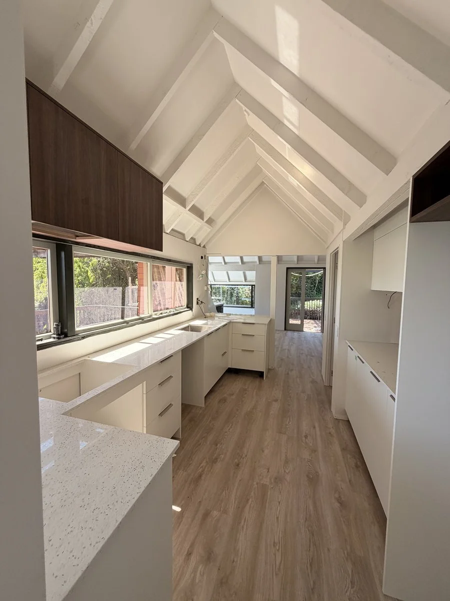 new-build-kitchen-interior-white-cabinetry-vaulted-ceiling.jpg