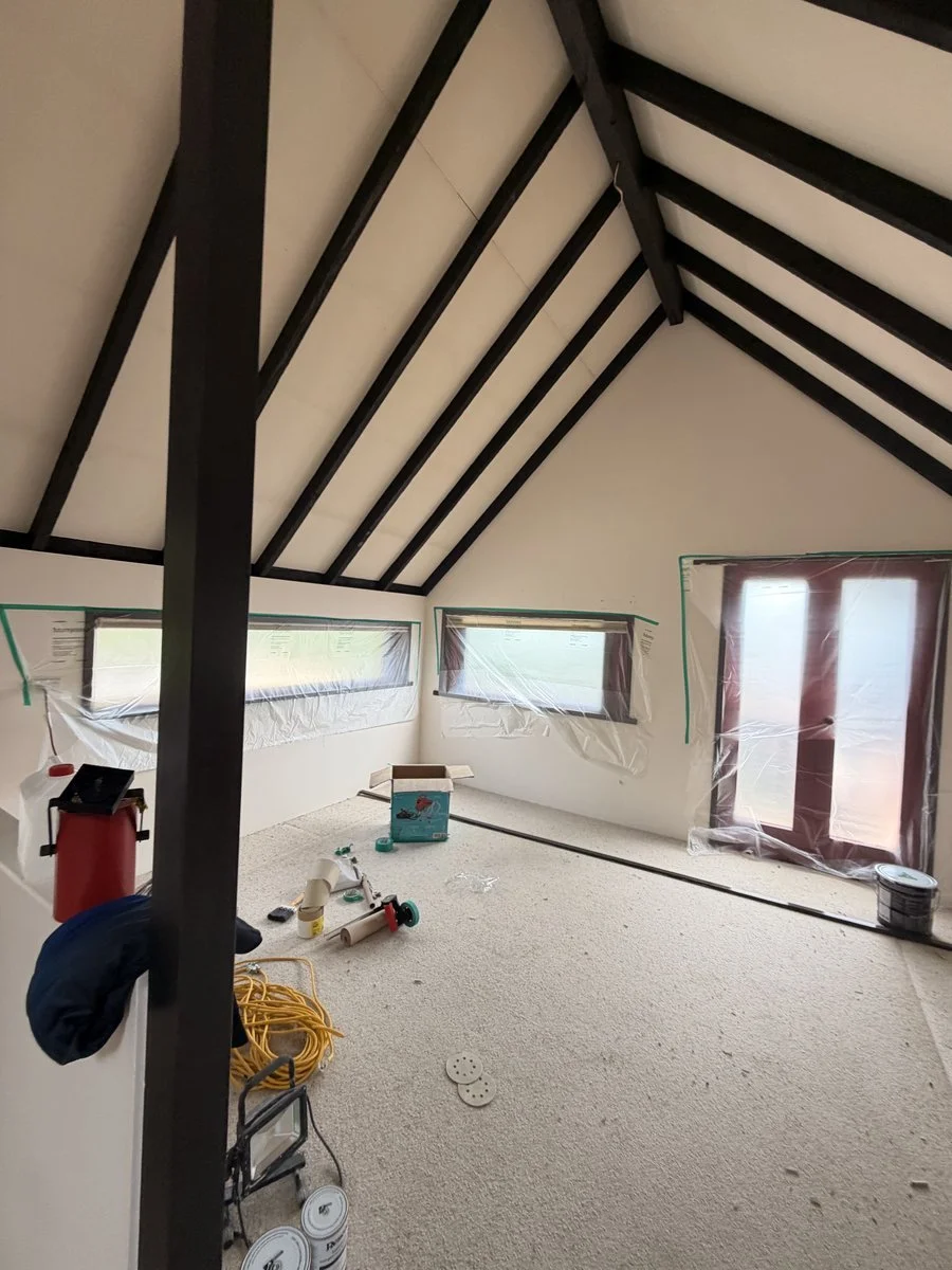 interior-loft-room-painting-in-progress-dark-beams-white-ceiling.jpg