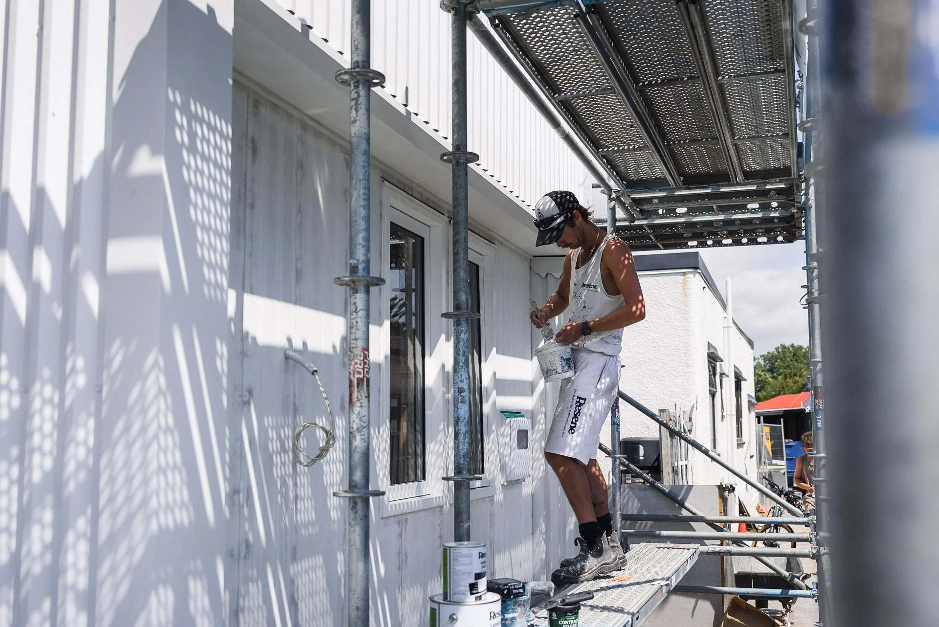 painter-on-scaffolding-exterior-white-cladding.jpg