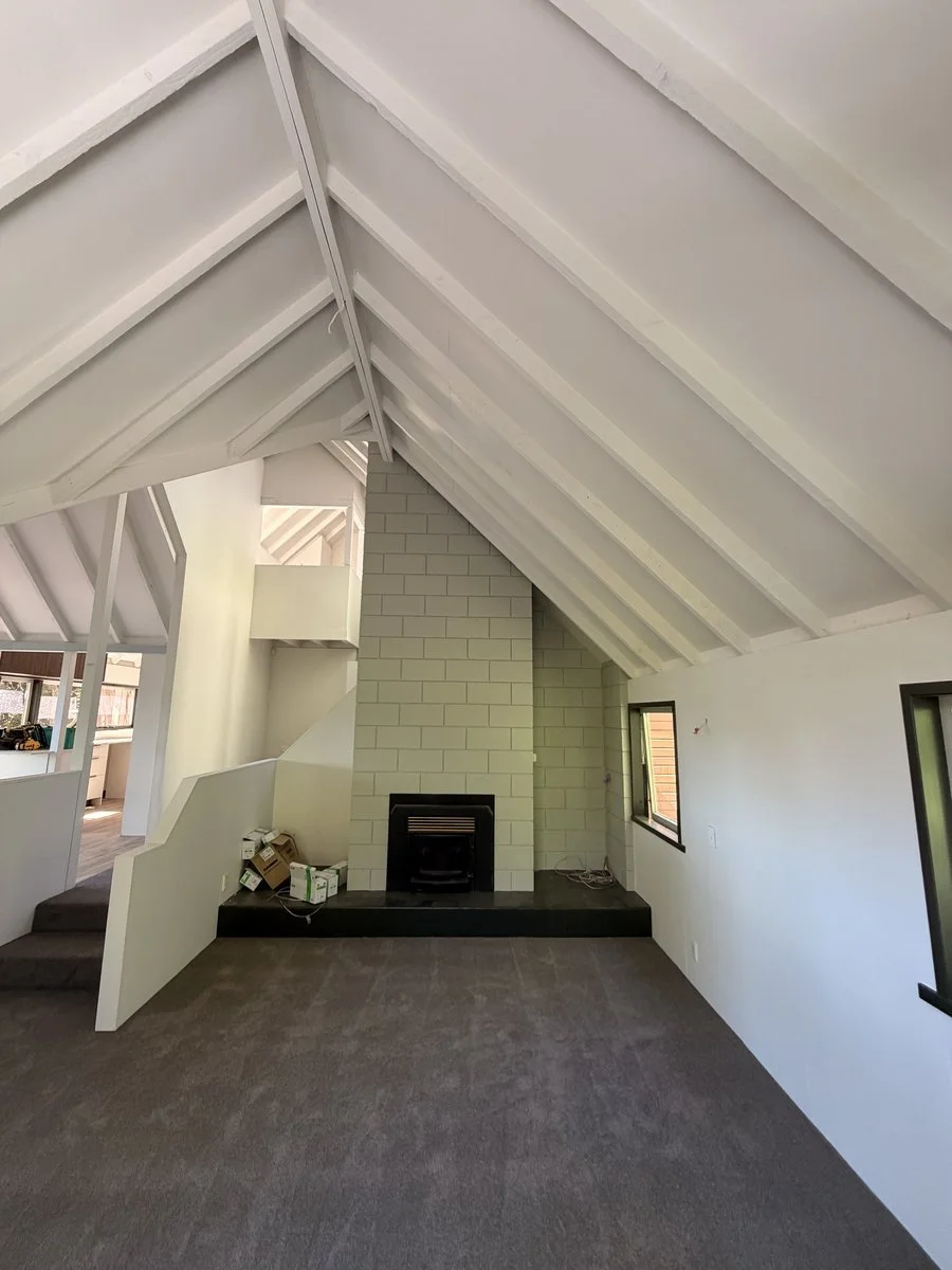 interior-vaulted-ceiling-white-beams-fireplace-renovation.jpg