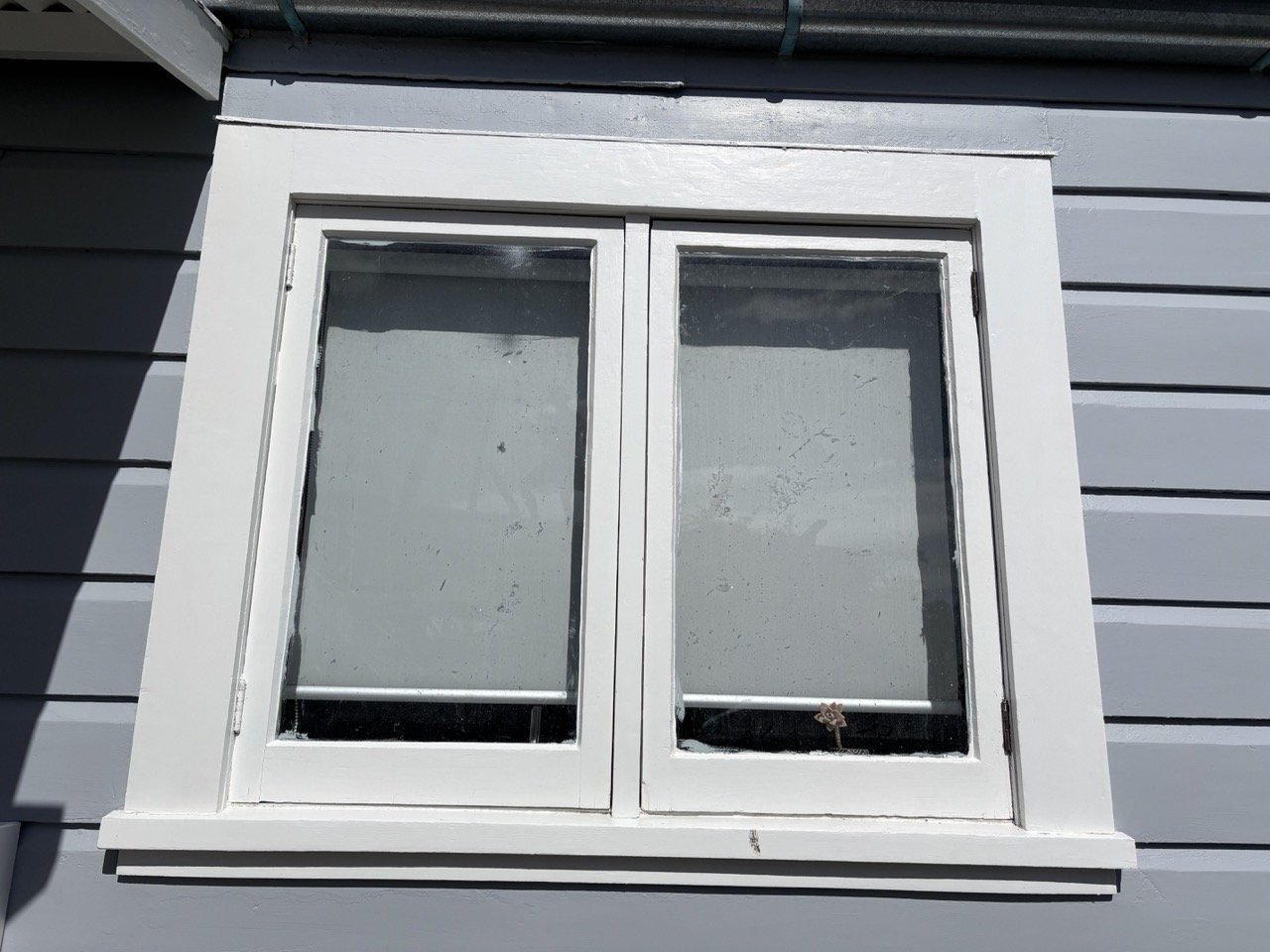 kennedy-road-exterior-window-white-trim-grey-weatherboard.jpg