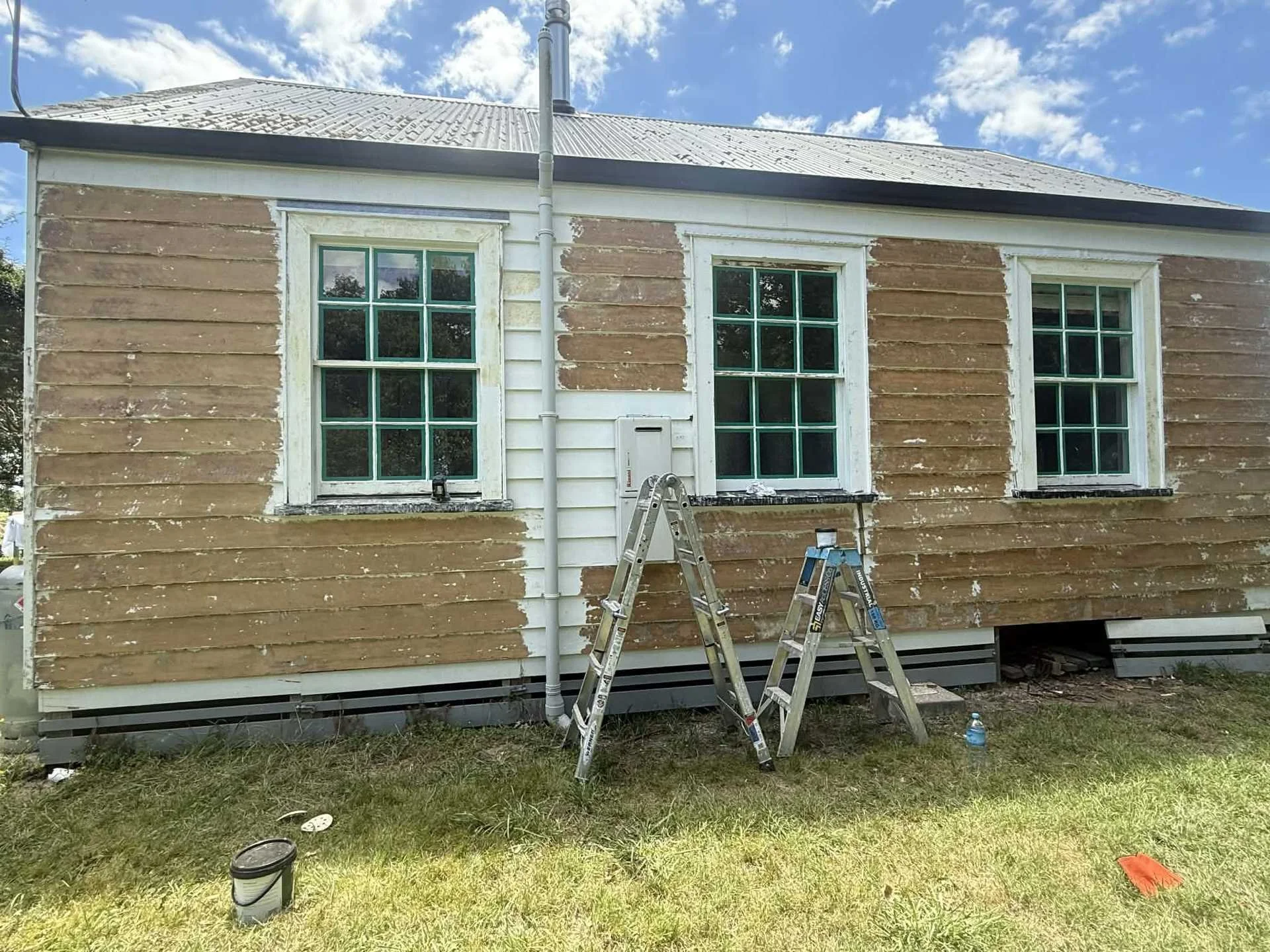 villa-exterior-paint-stripped-prep-ladders.jpg