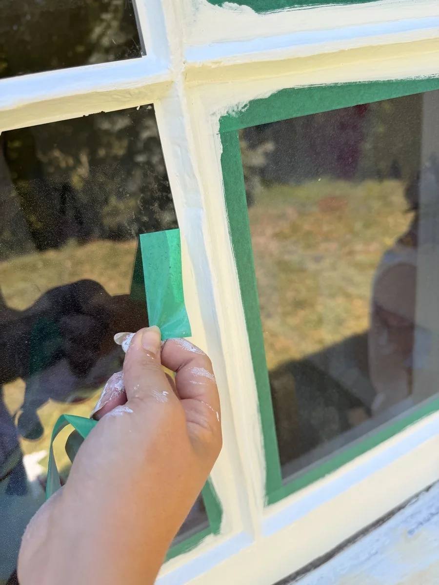 painter-removing-masking-tape-window-trim-cream-paint.jpg