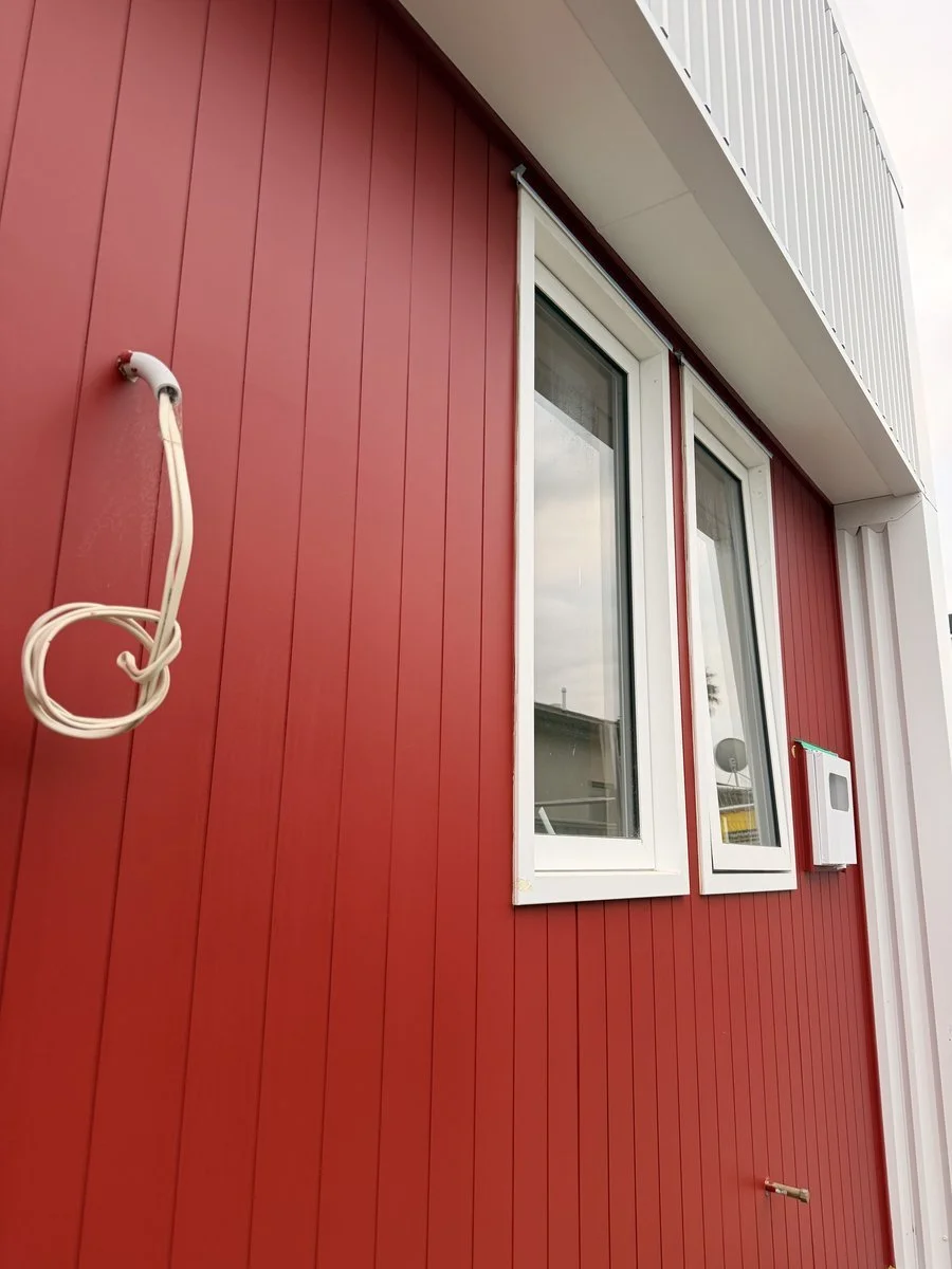 herrick-st-exterior-red-vertical-cladding-white-trim-window.jpg