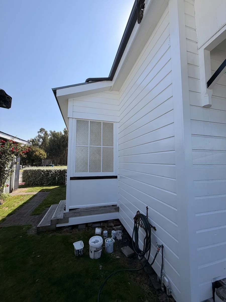 exterior-repaint-white-weatherboard-side-elevation-paint-tins.jpg