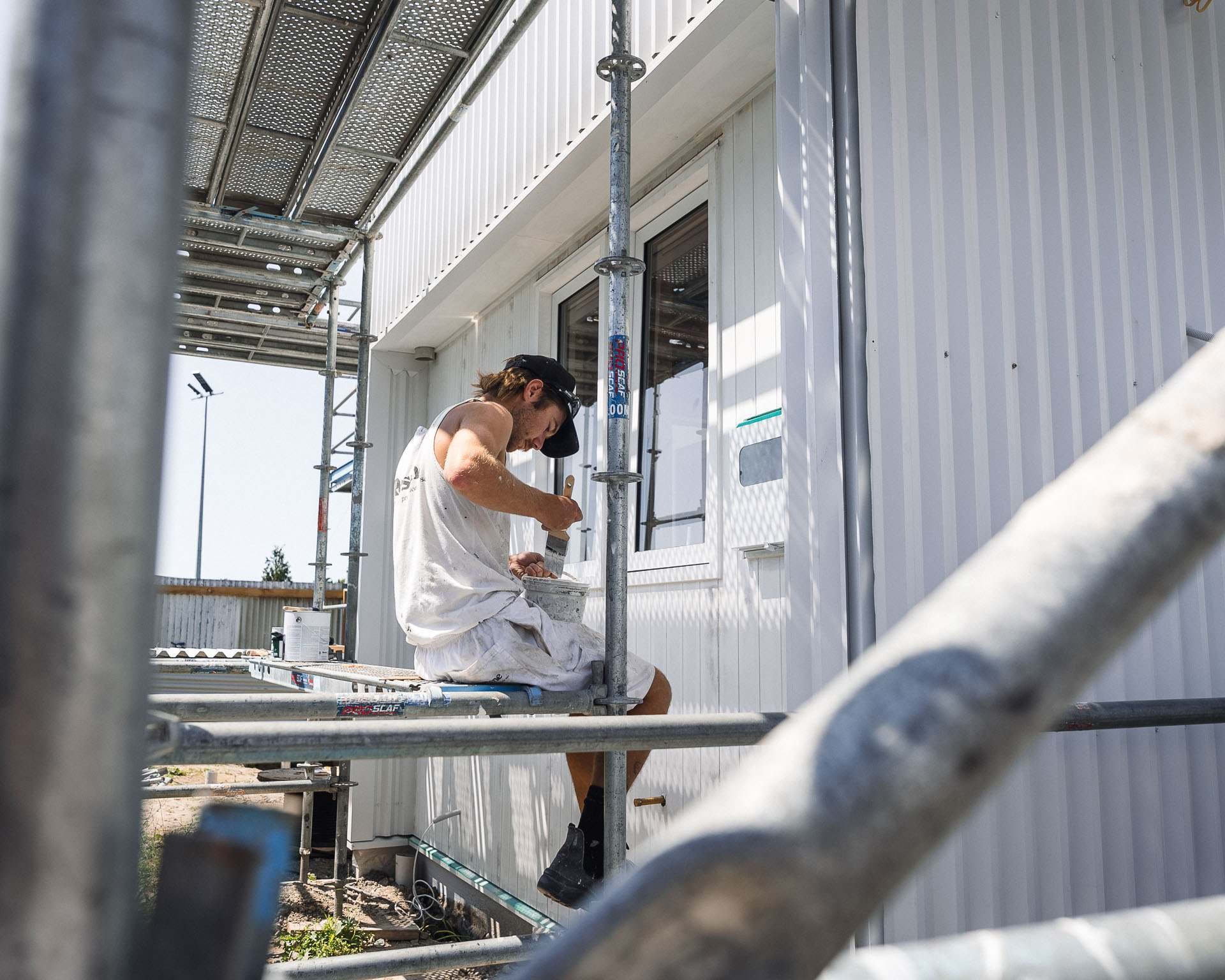 painter-on-scaffolding-exterior-trim-detail-work.jpg