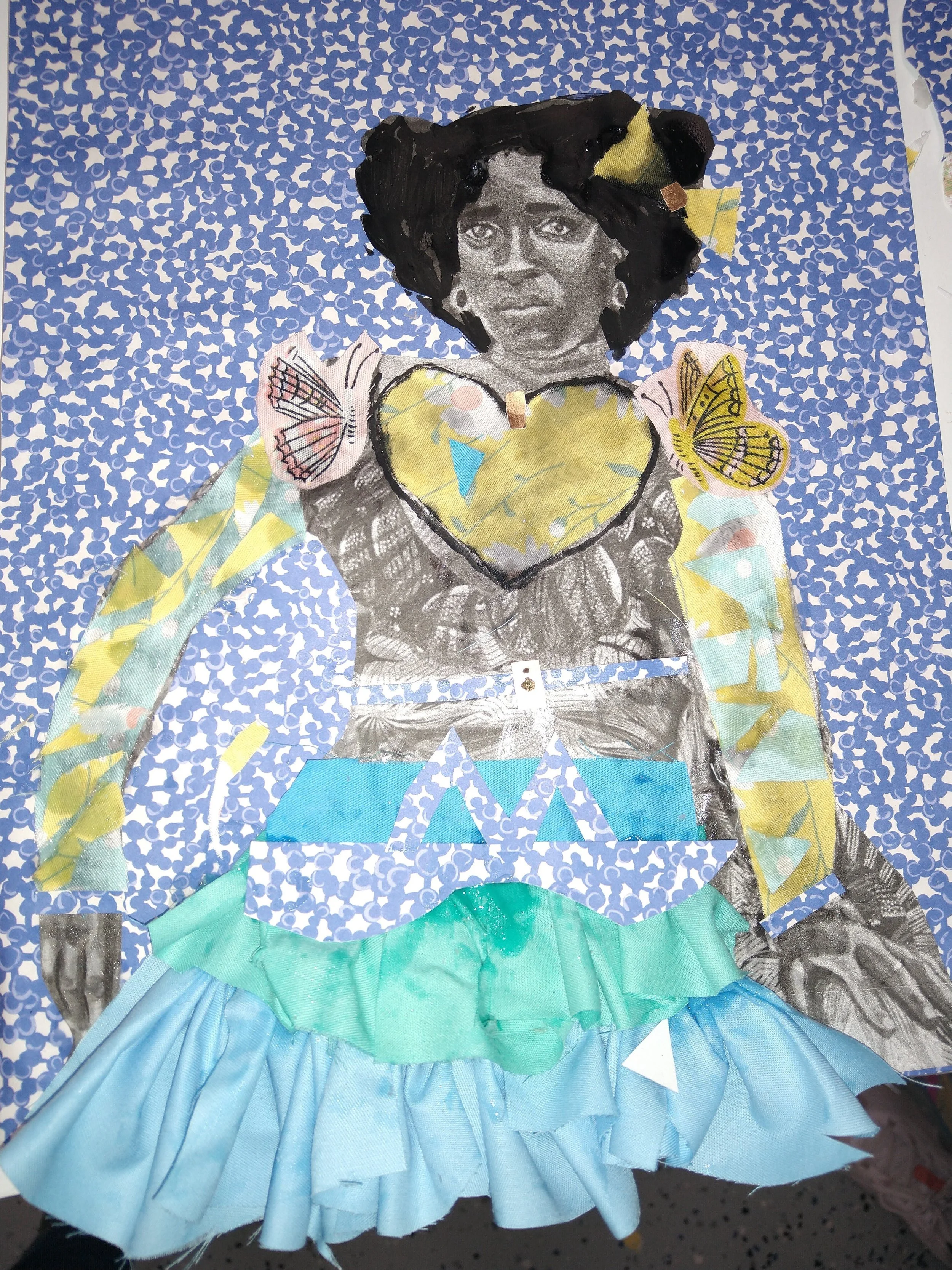A mixed media collage of a woman with a serious expression, featuring a black and white photograph of her face and colorful fabric and paper elements forming her clothing and background.