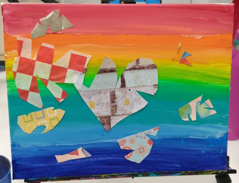 Colorful painting of a rainbow sky with various origami shapes, including a heart in the center, flying birds, and abstract shapes.