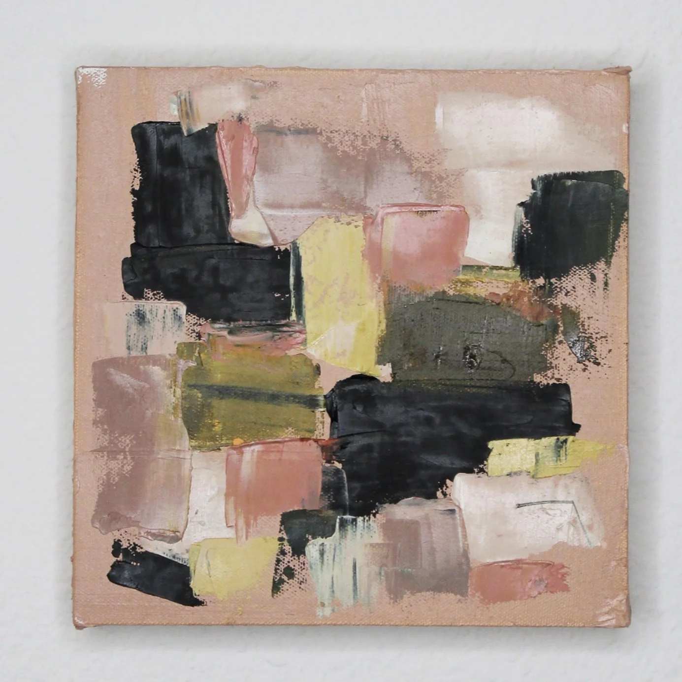 Abstract painting with black, pink, yellow, white, and beige brushstrokes on a small square canvas.