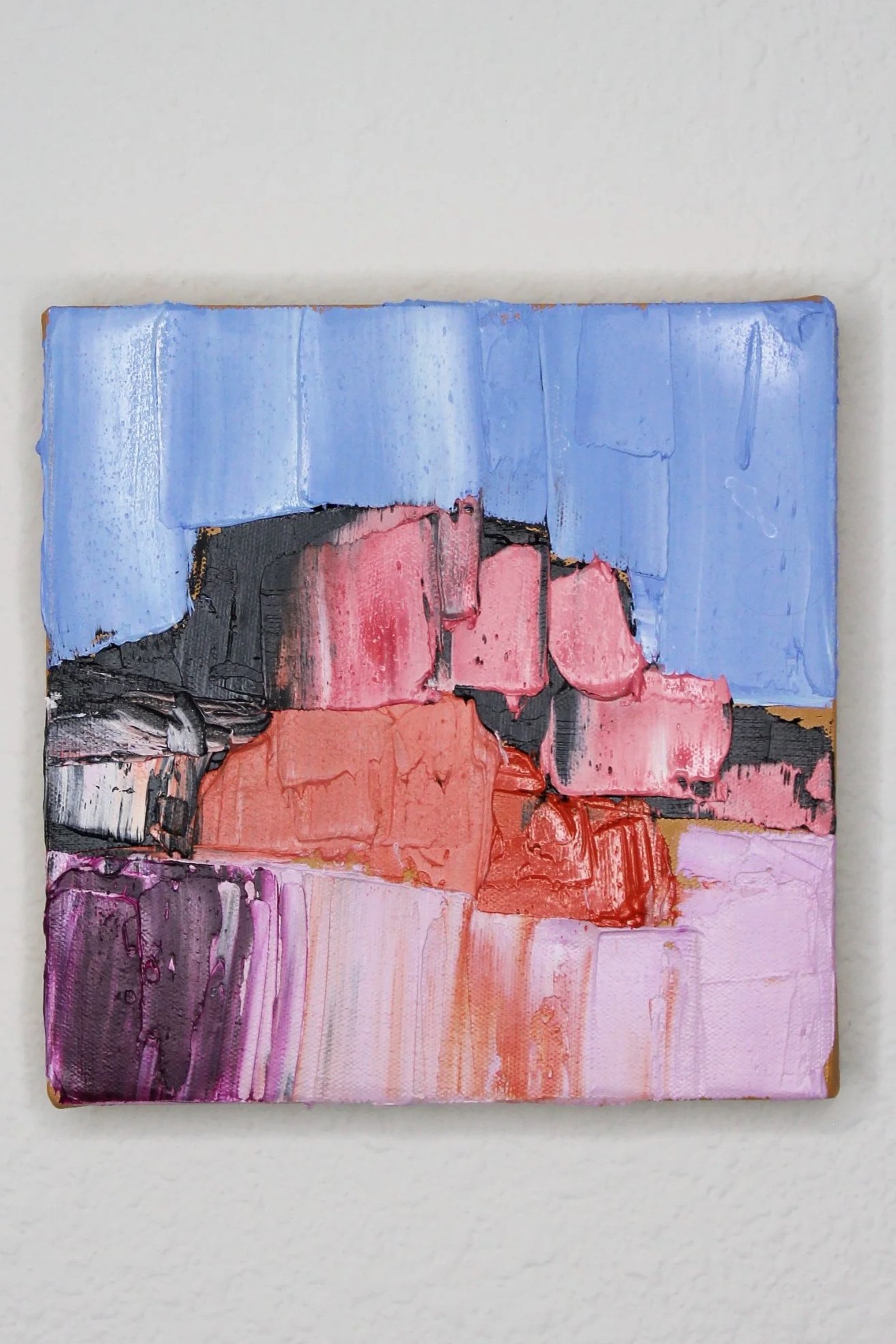 Abstract landscape painting with blue sky, pink and orange buildings, purple and black foreground.