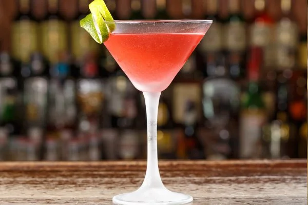 a photo of a martini glass containing a bright red cocktai