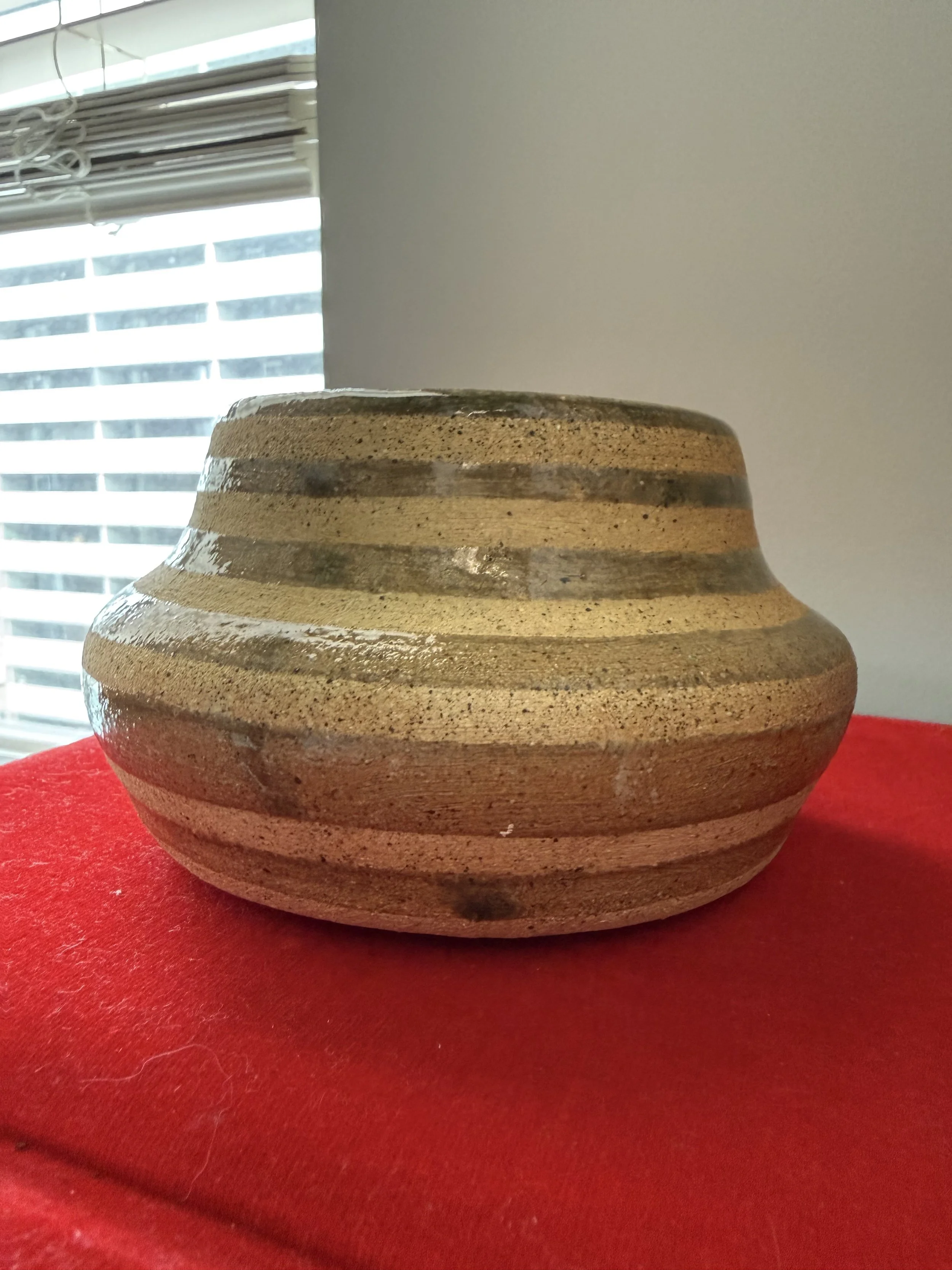 Short wide brown vase with unglazed stripes