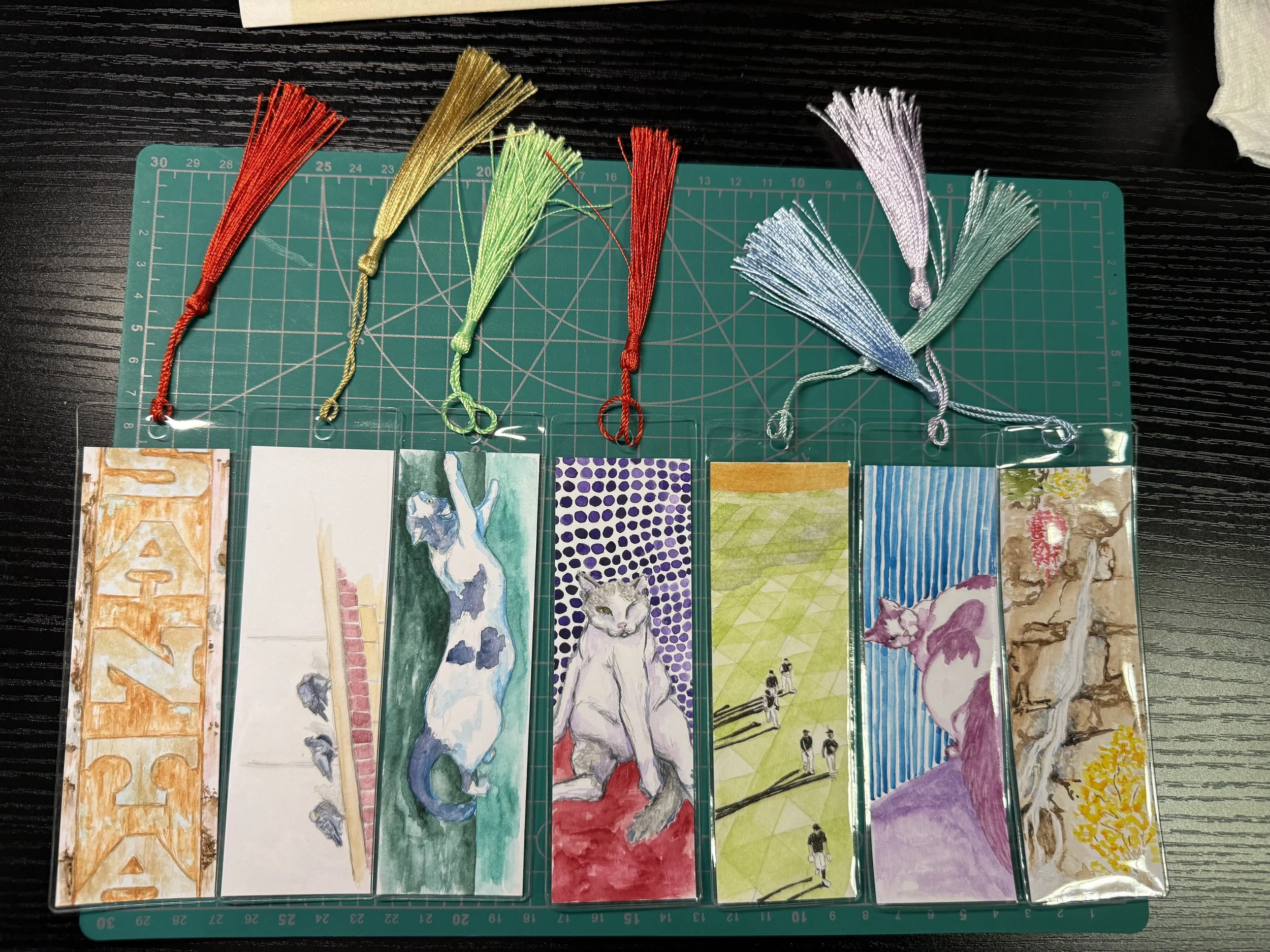 Six hand-painted bookmarks each with a different painting, subjects ranging from cats to pigeons to baseball.