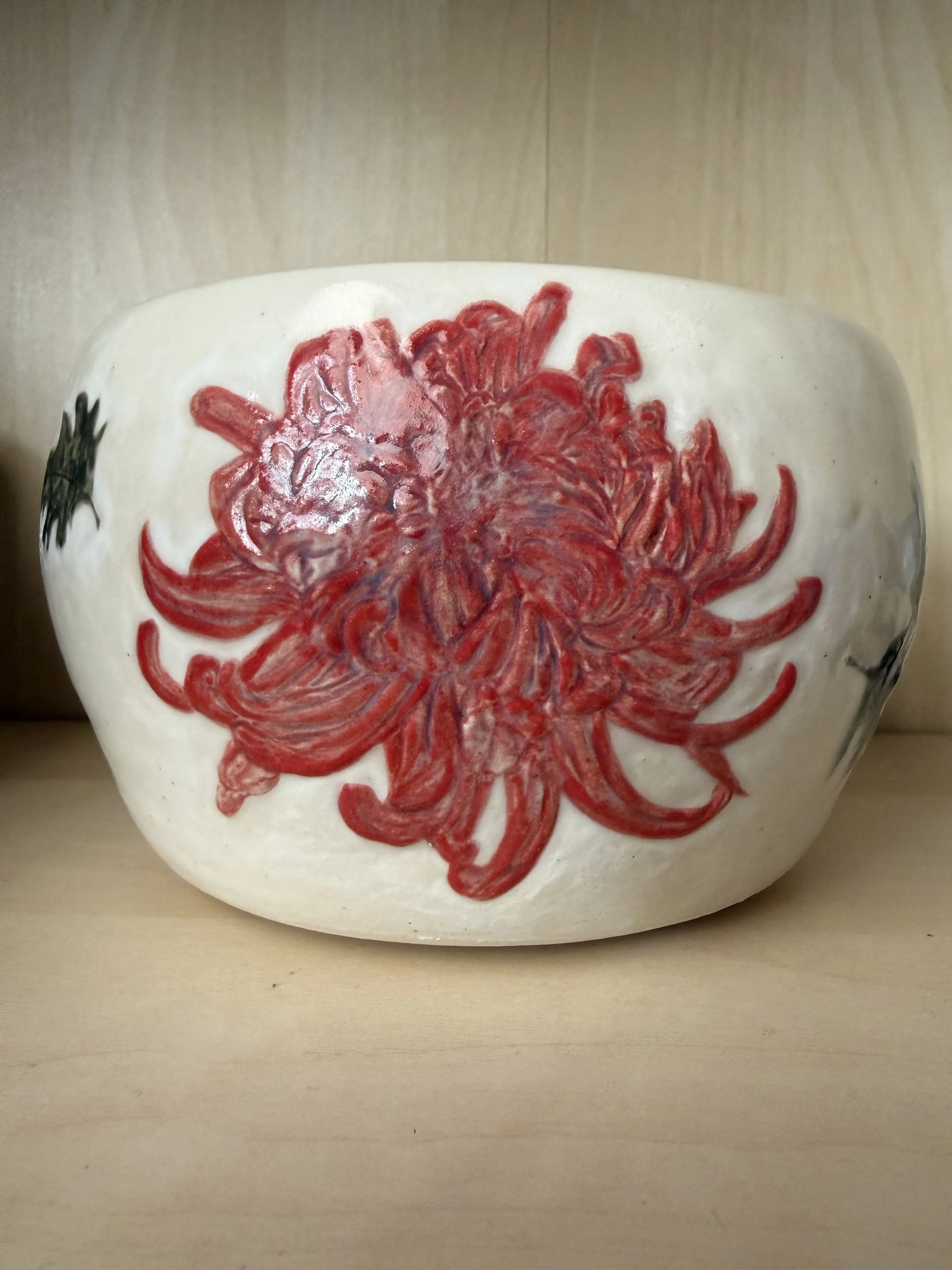 Ceramic bowl with a red and pink chrysanthemum carved and glazed