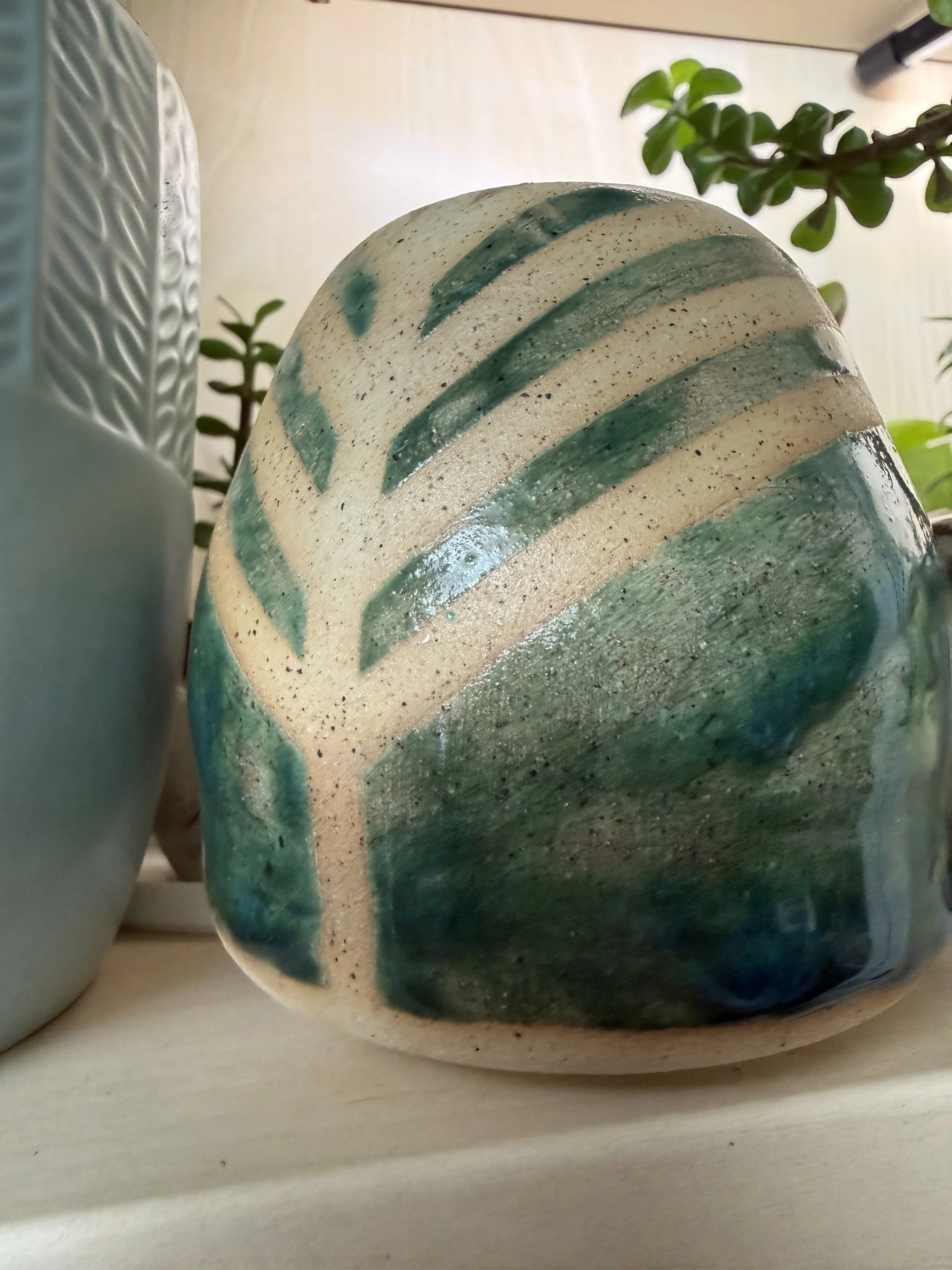 Small green ceramic vase with tree-shaped resist lines