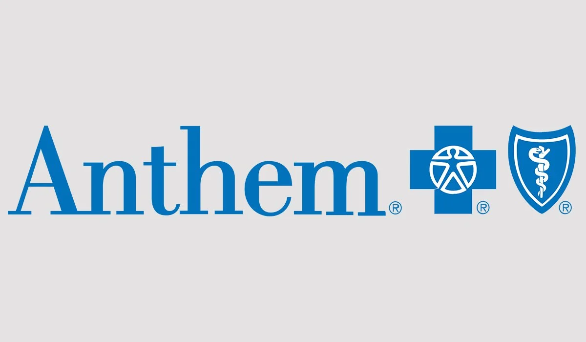 Anthem health insurance logo with blue text and symbols on a gray background.
