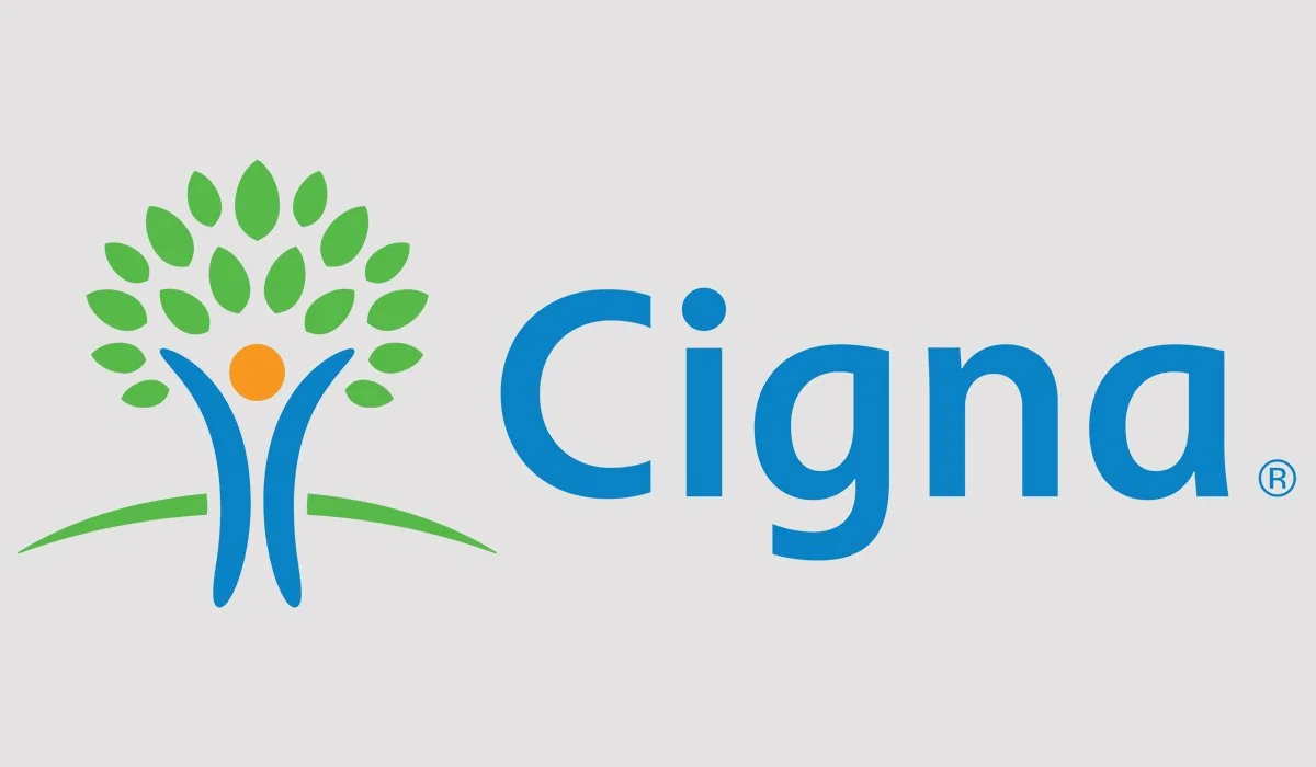 Cigna logo featuring a stylized tree with green leaves, an orange circle representing a person or sun, and the blue company name 'Cigna'.