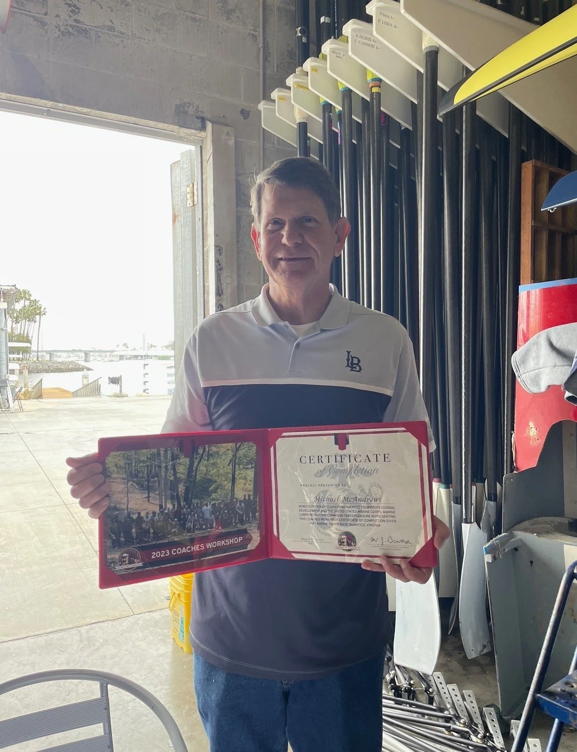 Mike McAndrews poses with his coaching award.