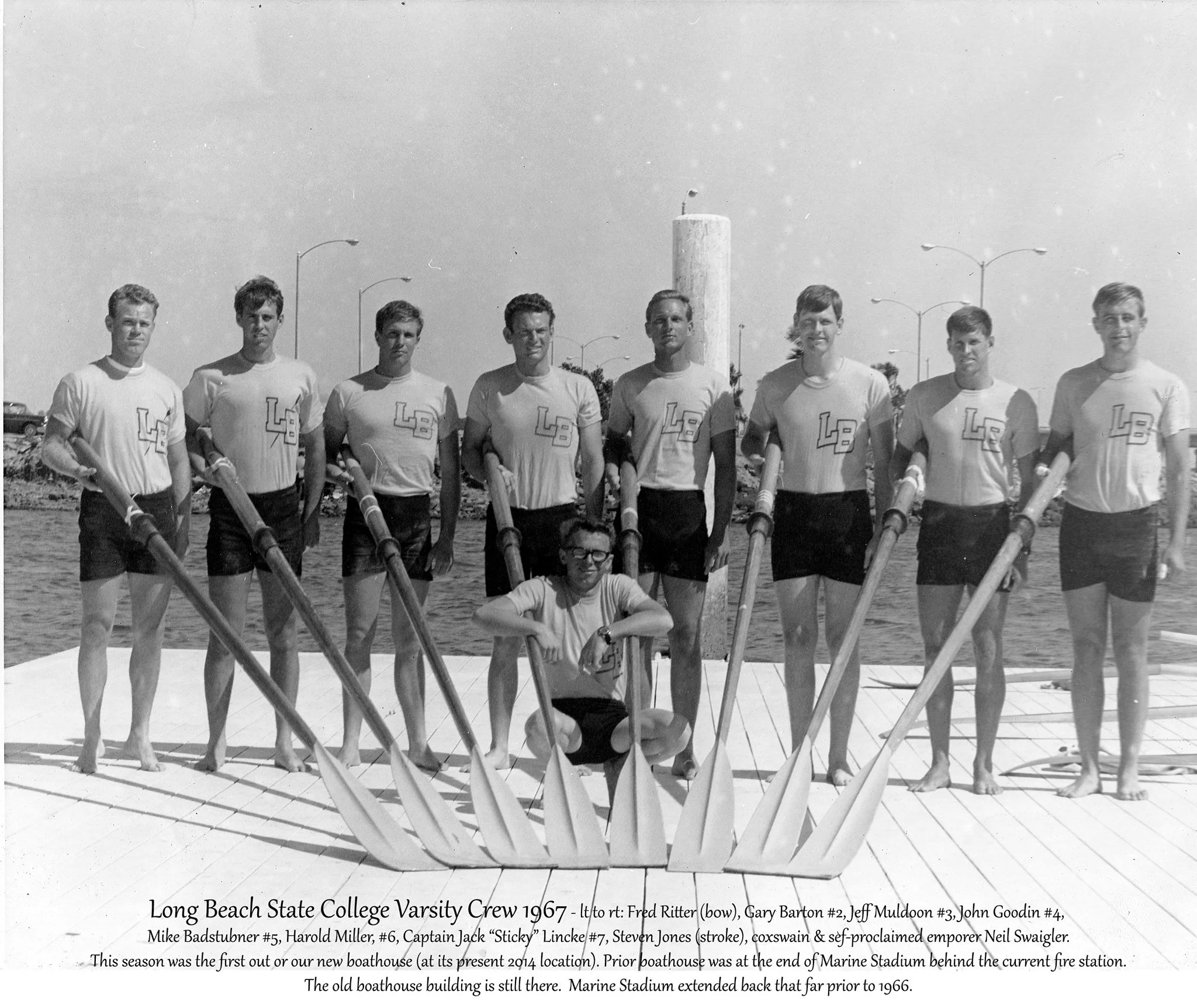 Long Beach State College varsity crew, 1967, on the dock with their oars.