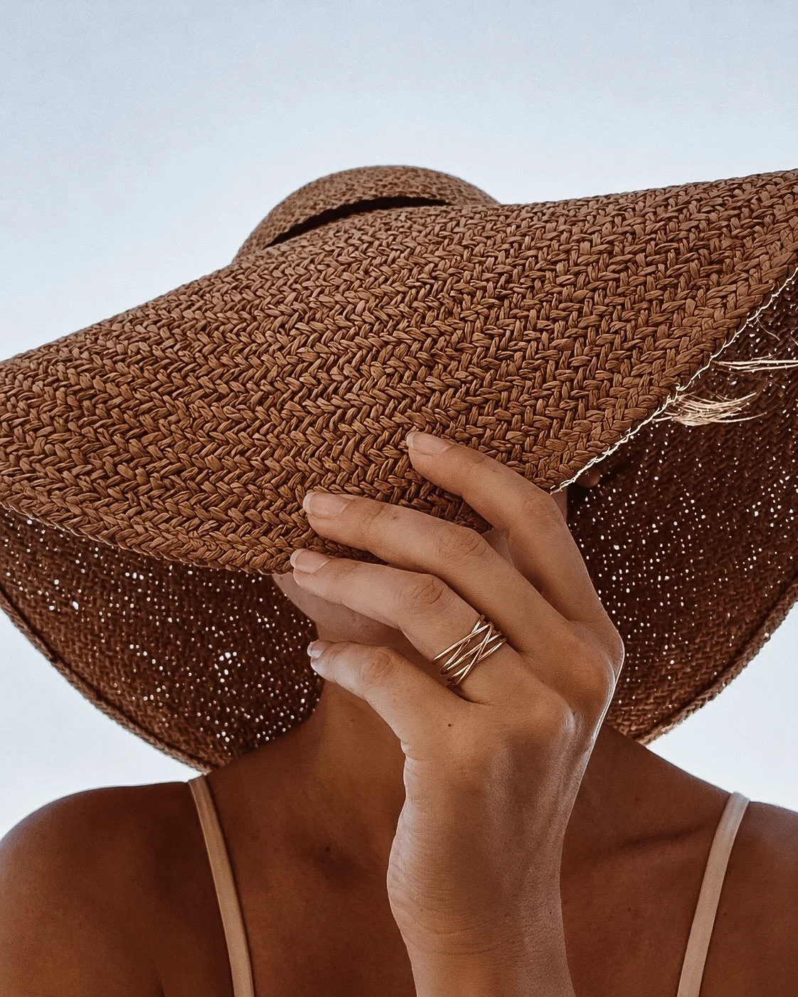 Woman wearing waterproof gold jewelry on a beach vacation