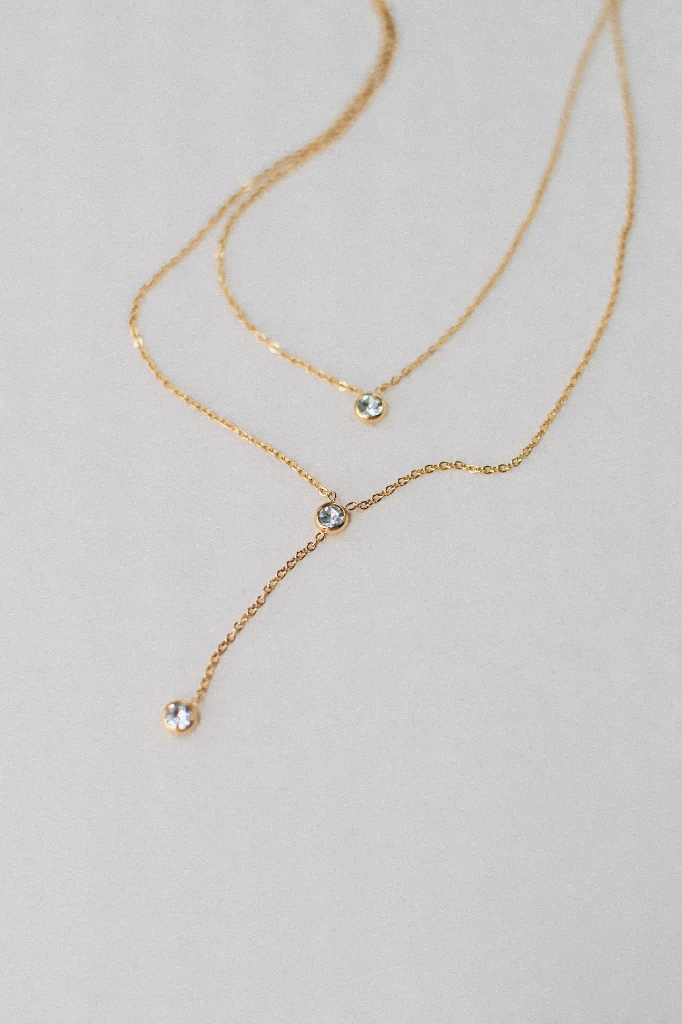 Bianca dainty gold double necklace with bezel-set cubic zirconia stones, available at Vienna Studio jewelry in Calgary.