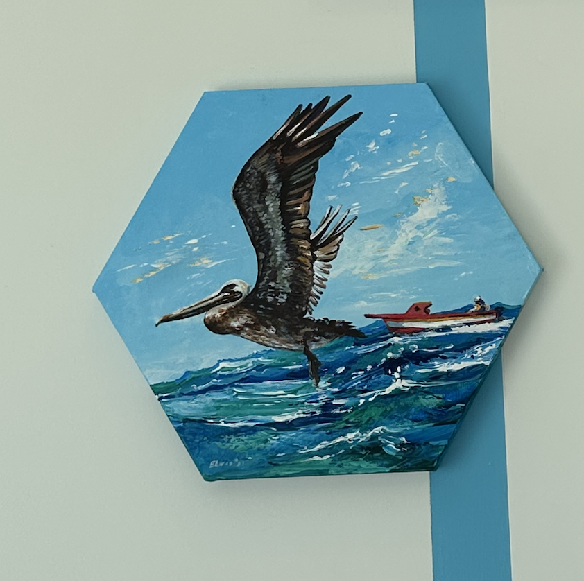 Painting of a pelican flying over the ocean with a boat nearby on the water.