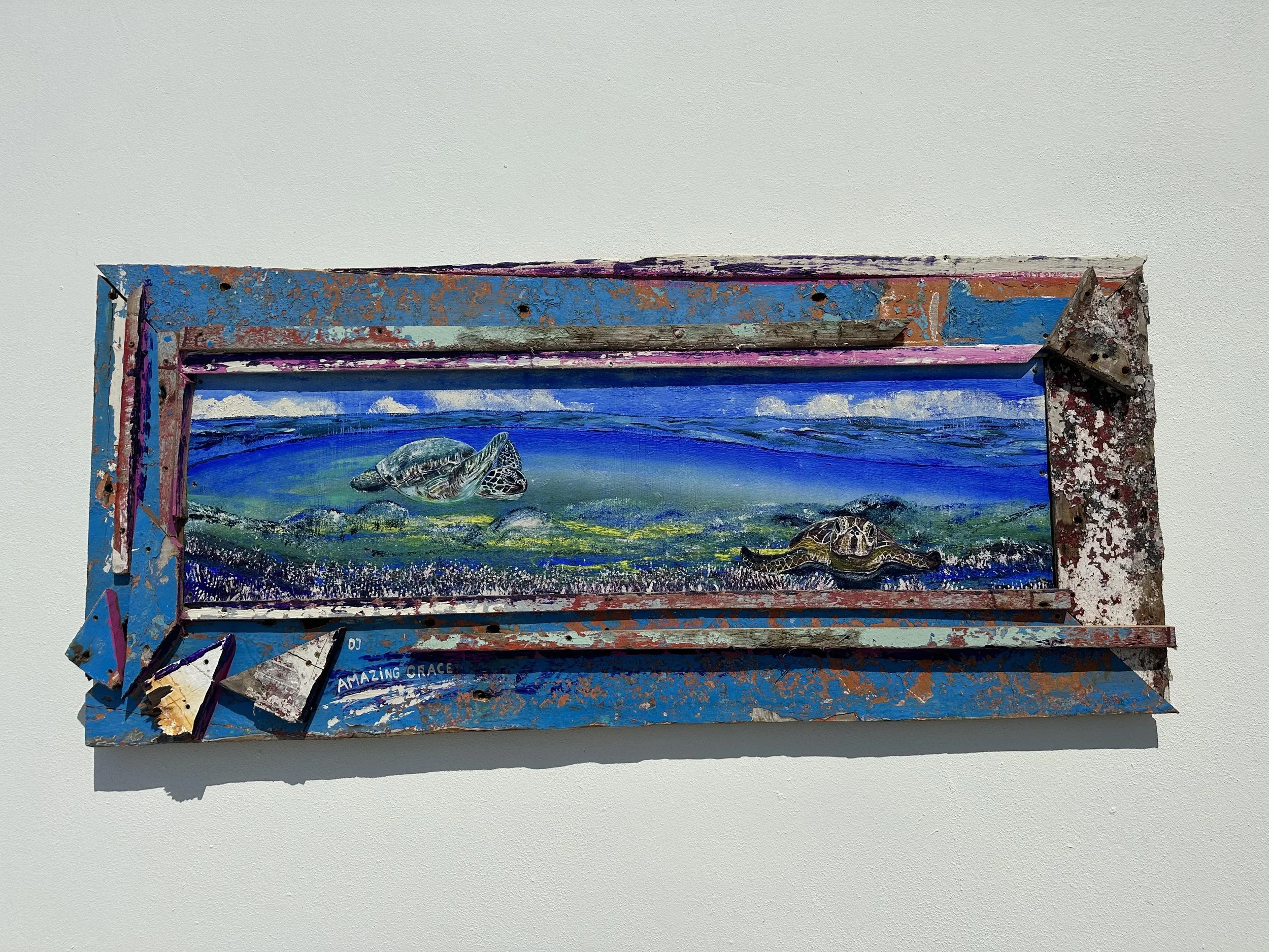 Mixed media artwork with painted sea turtles on a vibrant, abstract background framed by a distressed, colorful metal frame.