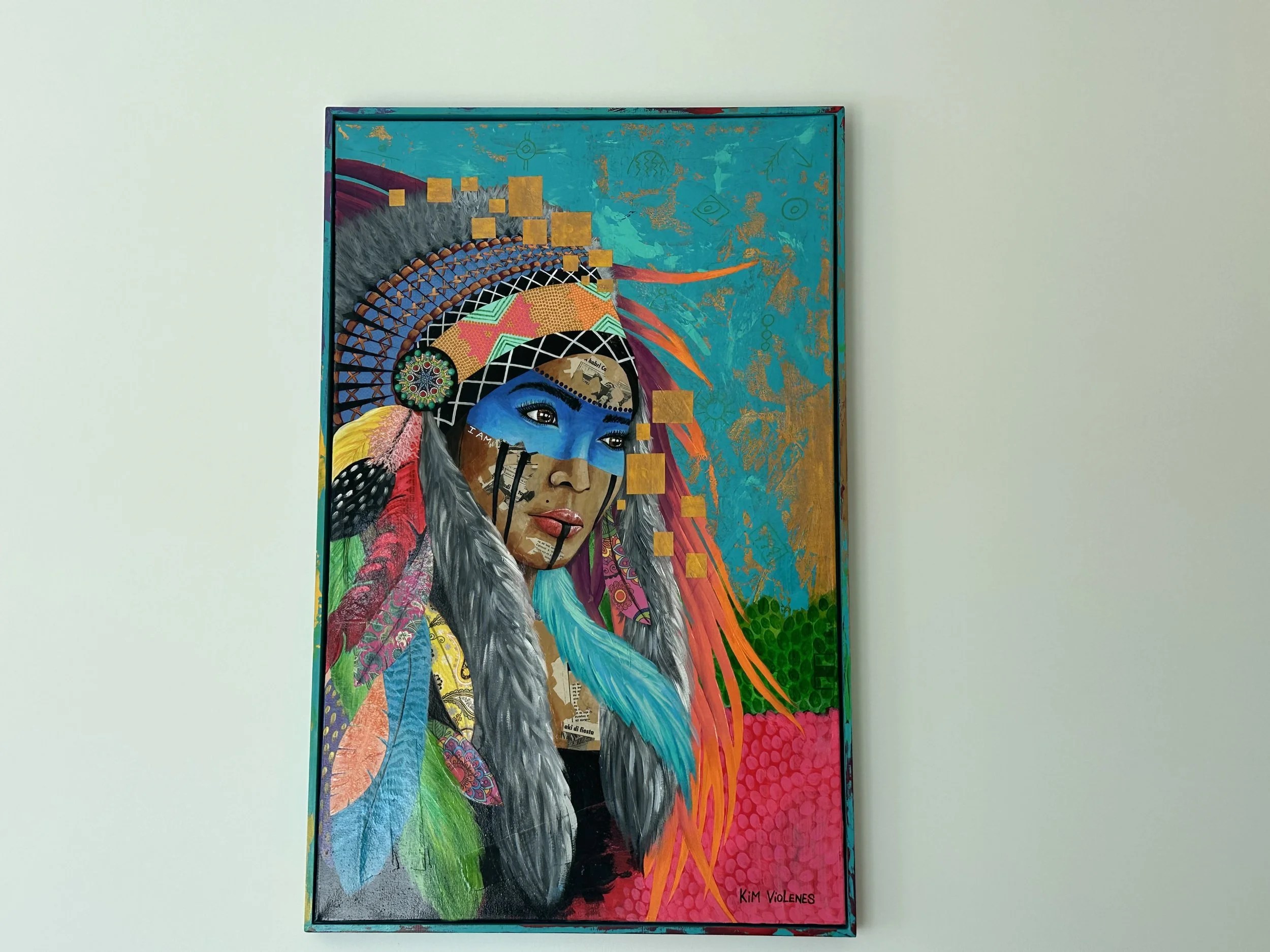 A colorful abstract painting of a woman with a blue face, indigenous attire, and long gray and blue hair. The background is vibrant with teal, pink, green, and gold accents.