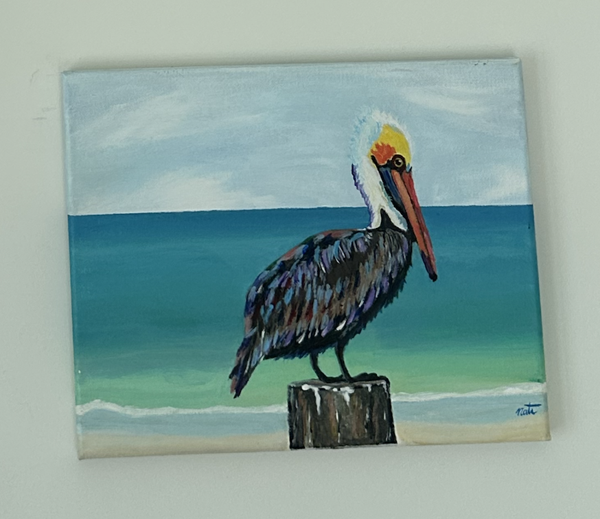 Painting of a pelican perched on a piece of wood at the beach, with ocean waves and a cloudy sky in the background.
