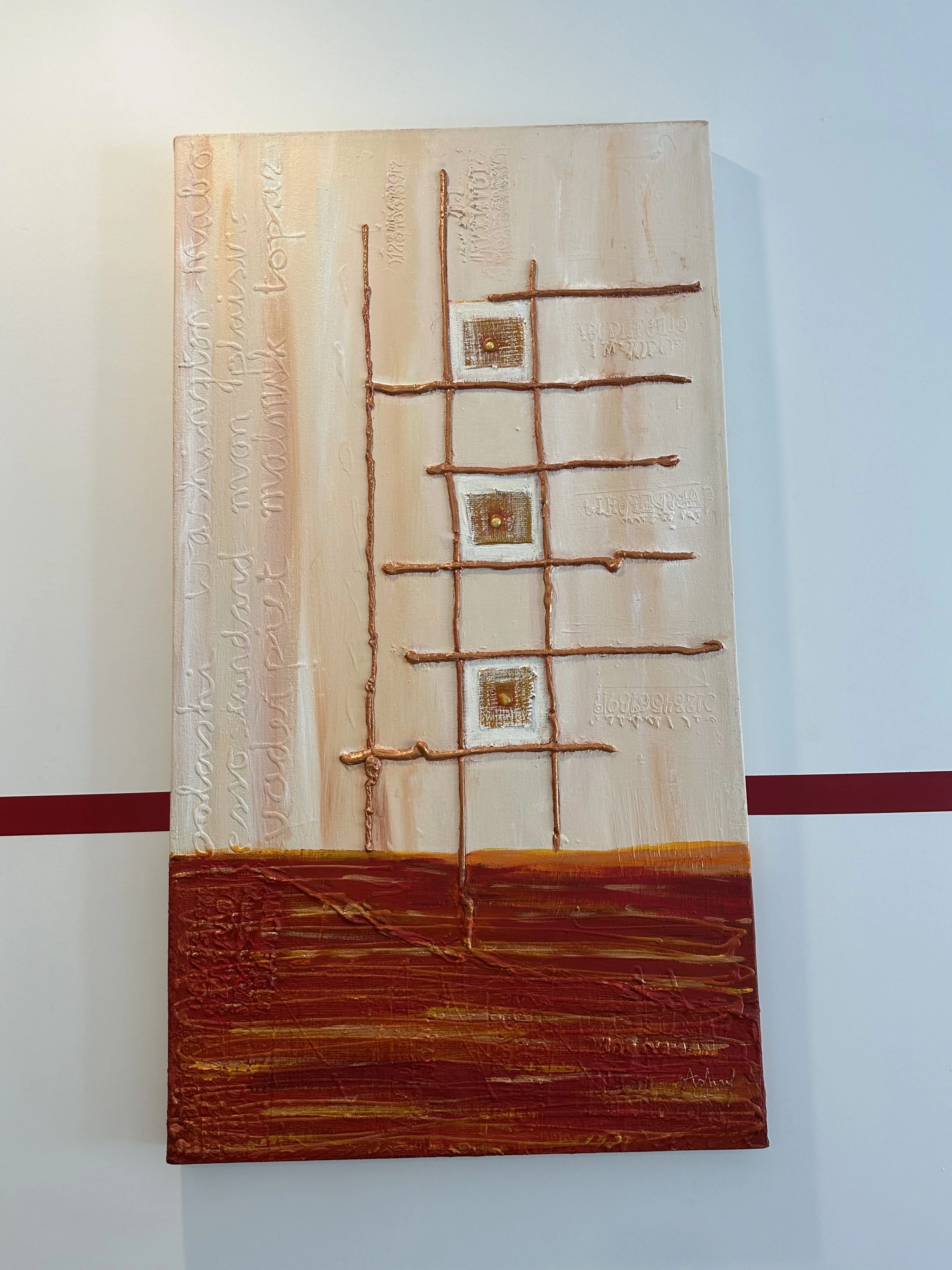 Abstract mixed media artwork with a cream-colored background, orange and brown textured bottom section, and thin, raised lines forming a grid pattern with small square elements. There is embossed or engraved text on the left and right sides of the ca