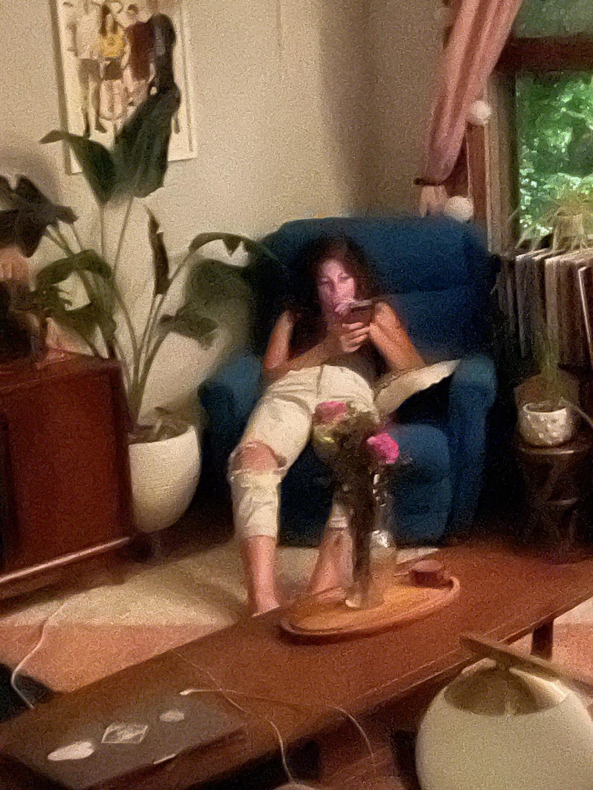 Regan Smith slouching on a chair staring at her phone