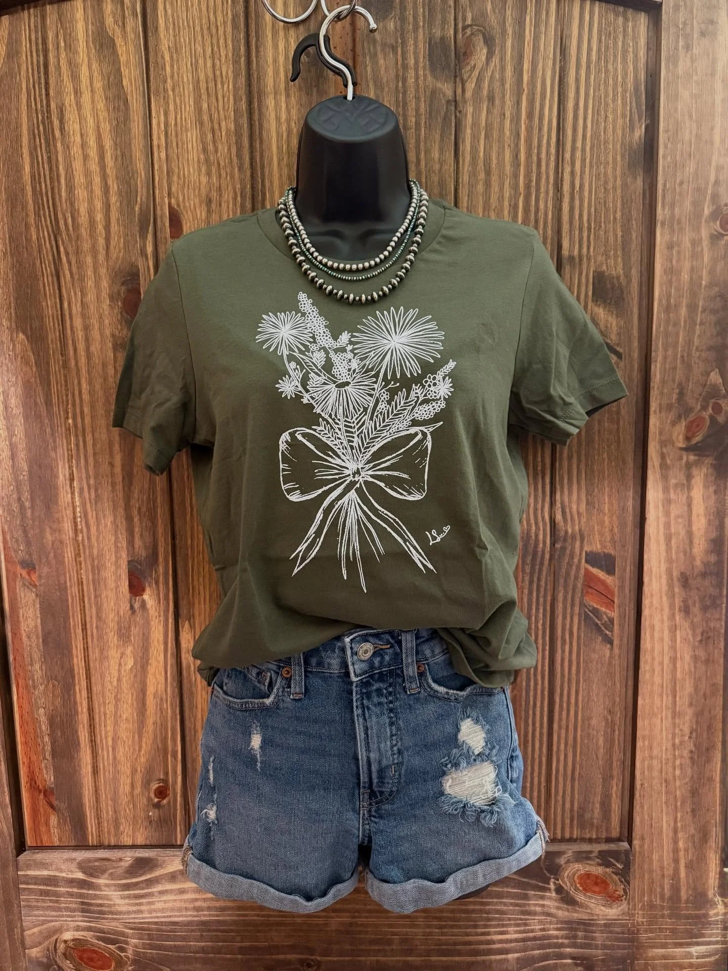 Bow with flowers design:

Printed on military green Women&rsquo;s Bella canvas

Sizes: S-XL
$25

2X &amp; 3X
$29

Add $6 for shipping or you can pick up in Ramona, OK