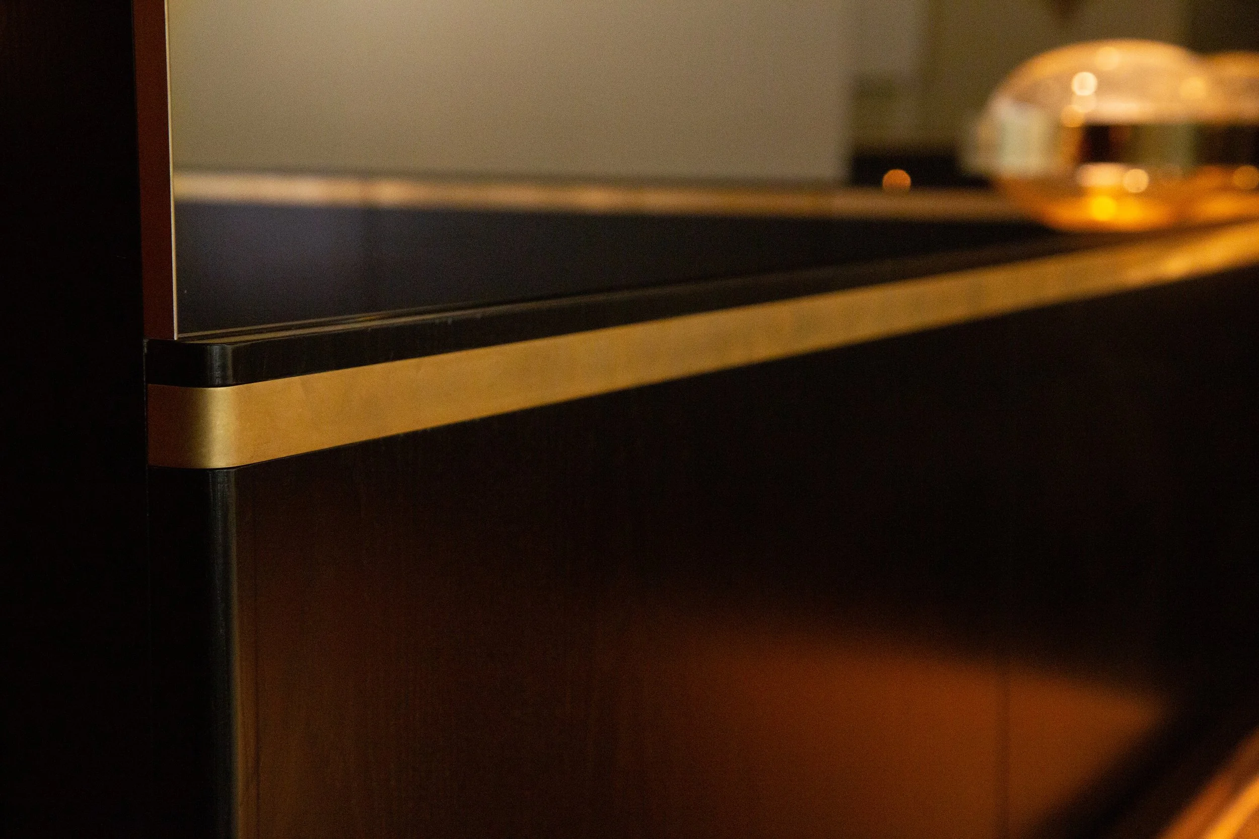 bronze inlay on stained oak panels. 