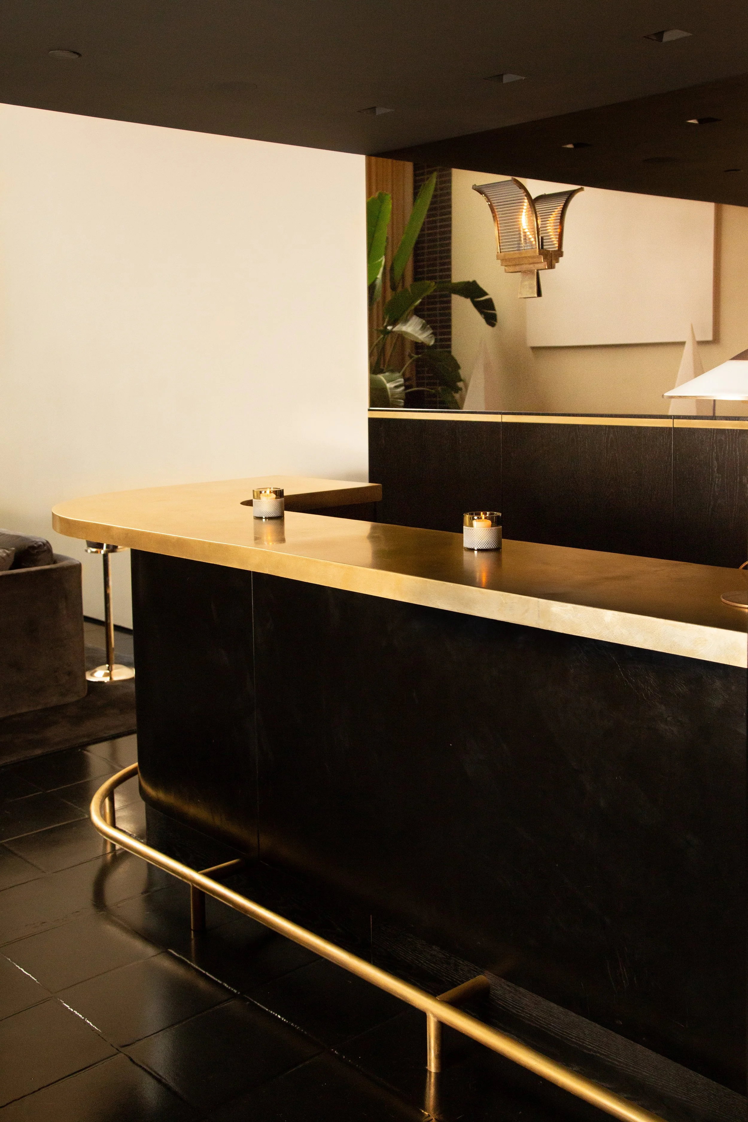 leather wrapped bar with bronze countertop and footrail