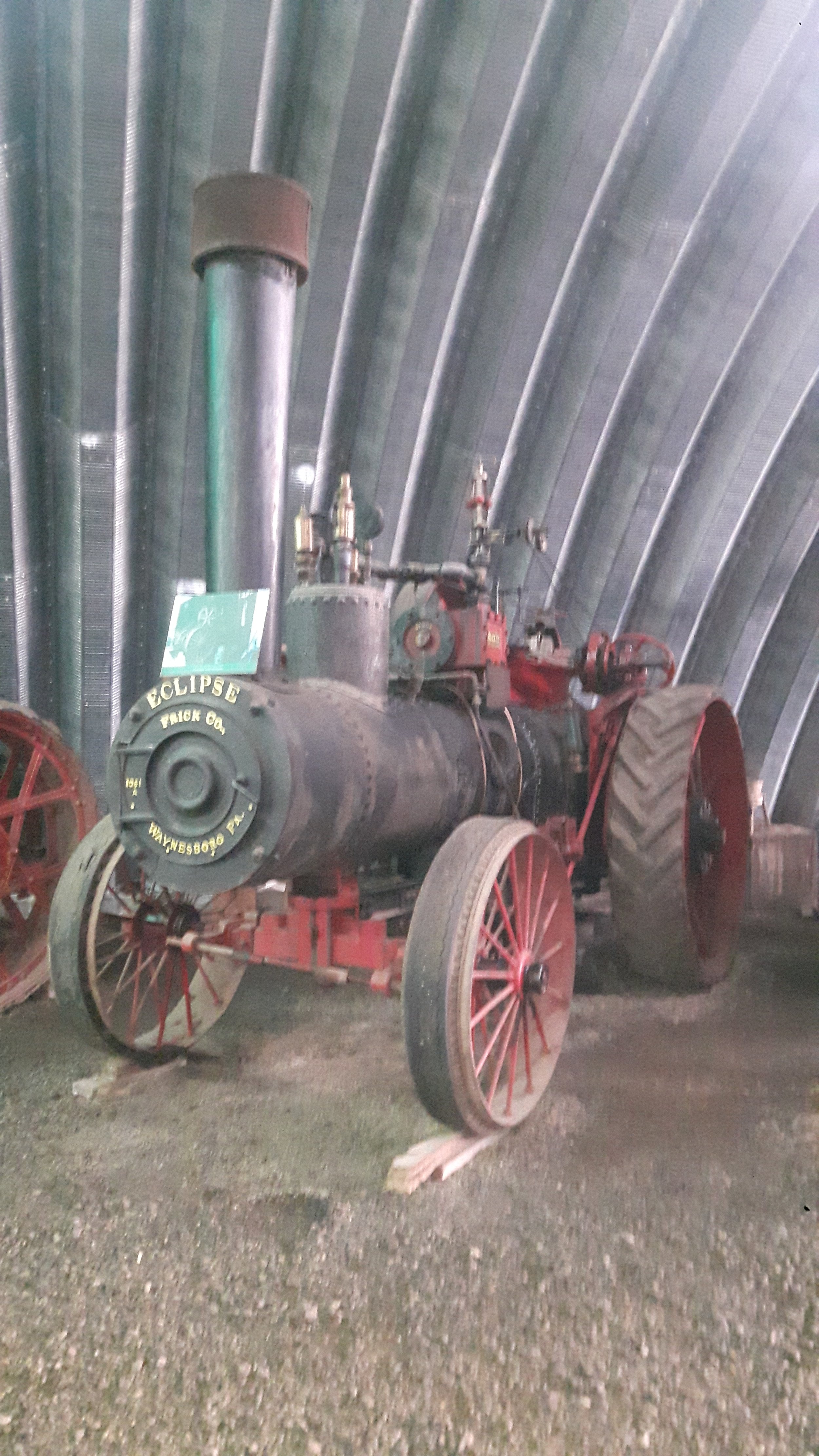 An antique steam tractor with large rear wheels and smaller front wheels, labeled 'Eclipse Truck Co. Wayne, W. Pa.'