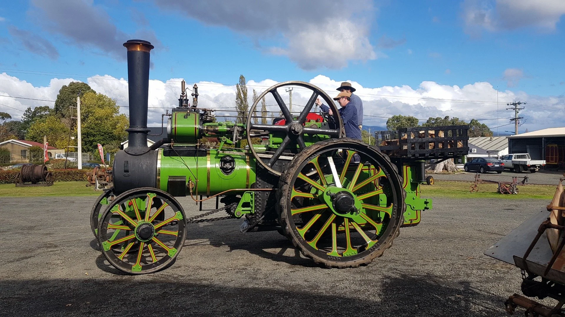 A vintage green and black steam tractor.