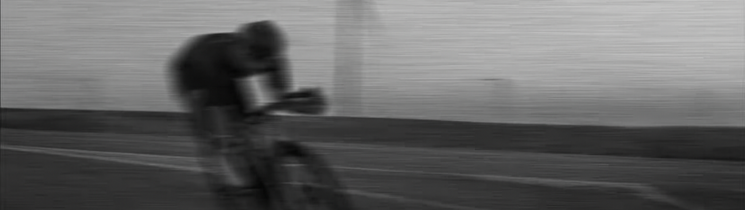 A person riding a bicycle on a paved road
