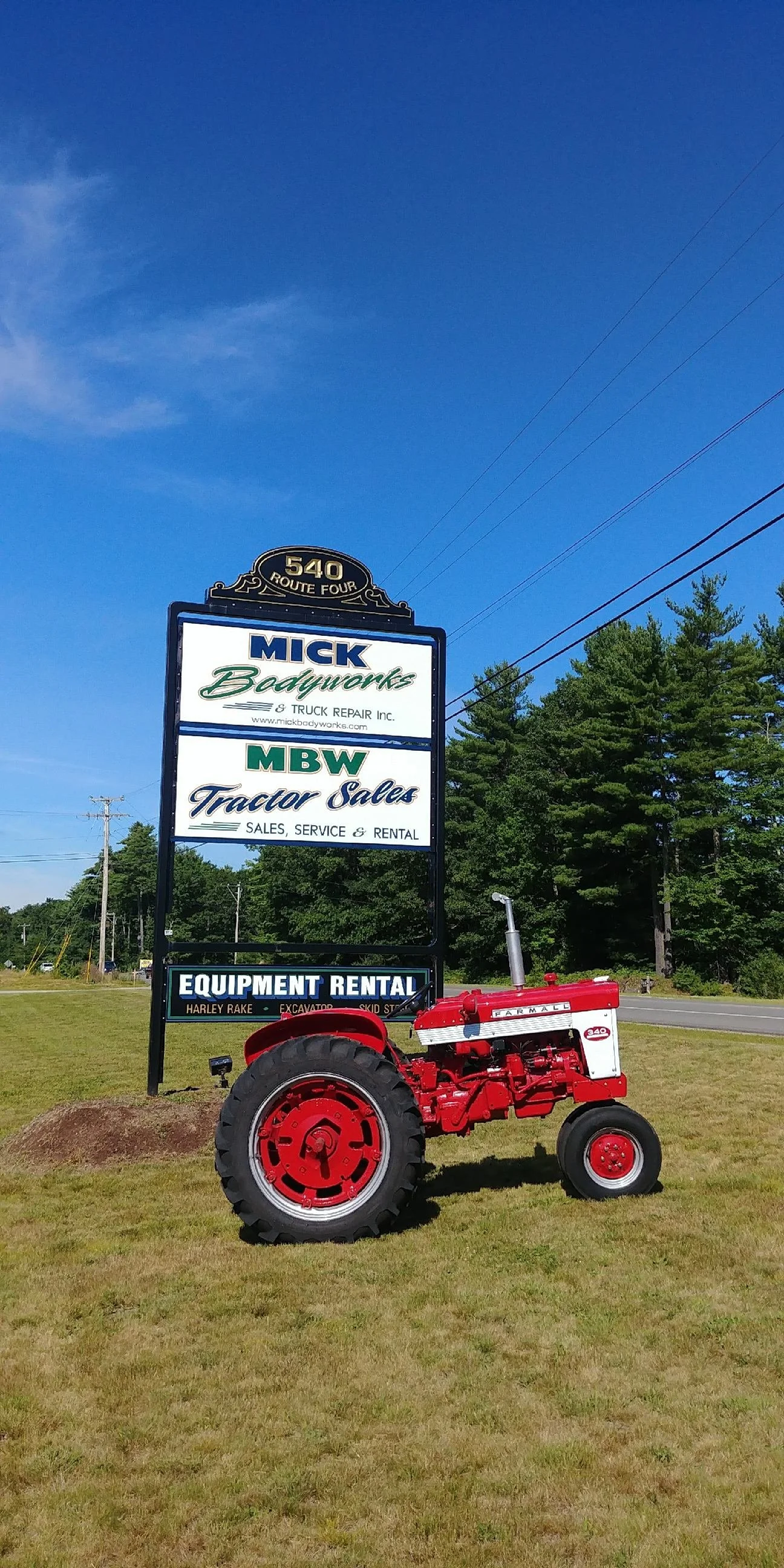 Tractor in front of the MBW Business sign