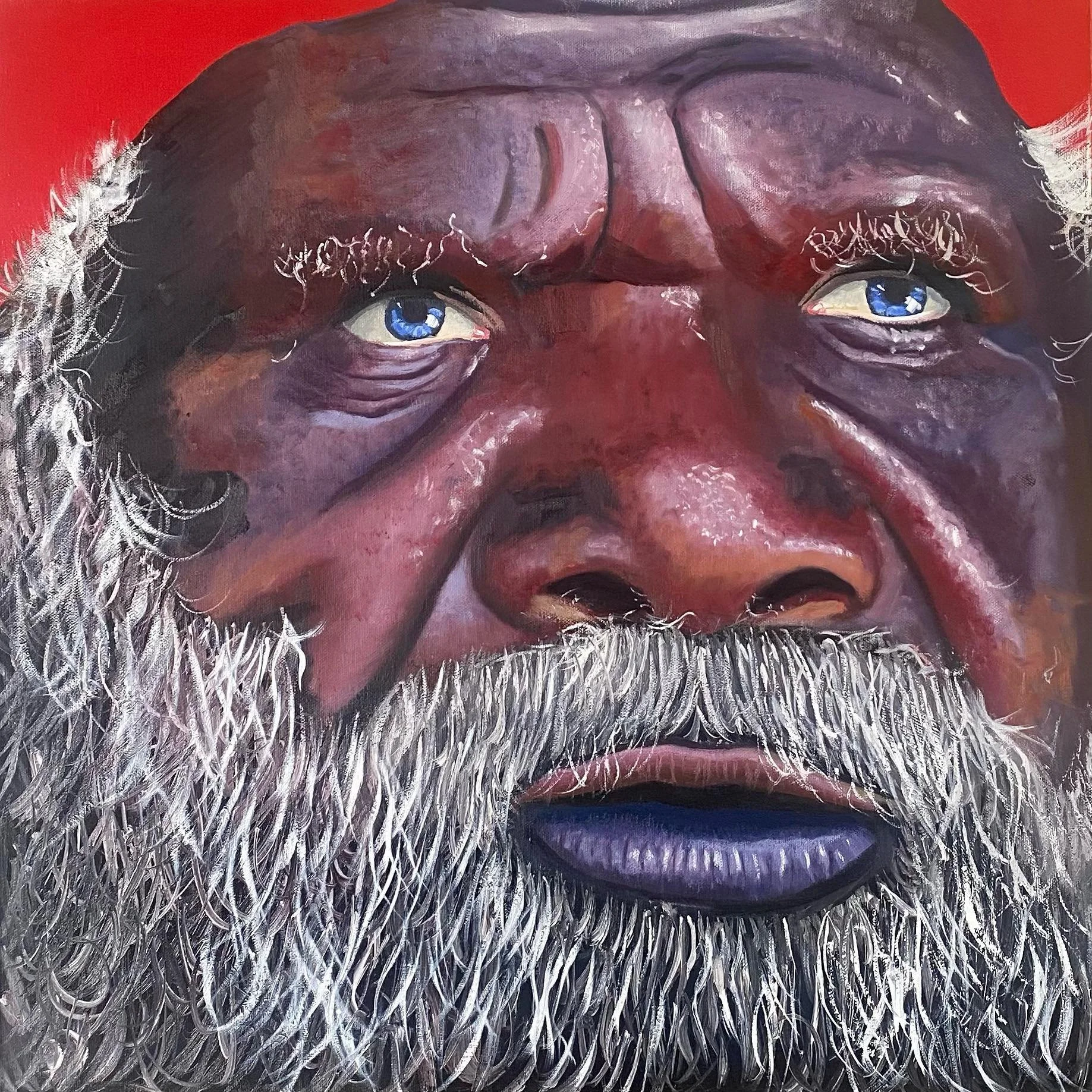 Close-up of a painting of an Indigenous Elder with a long white beard, expressive eyes, and dark skin, against a red background.