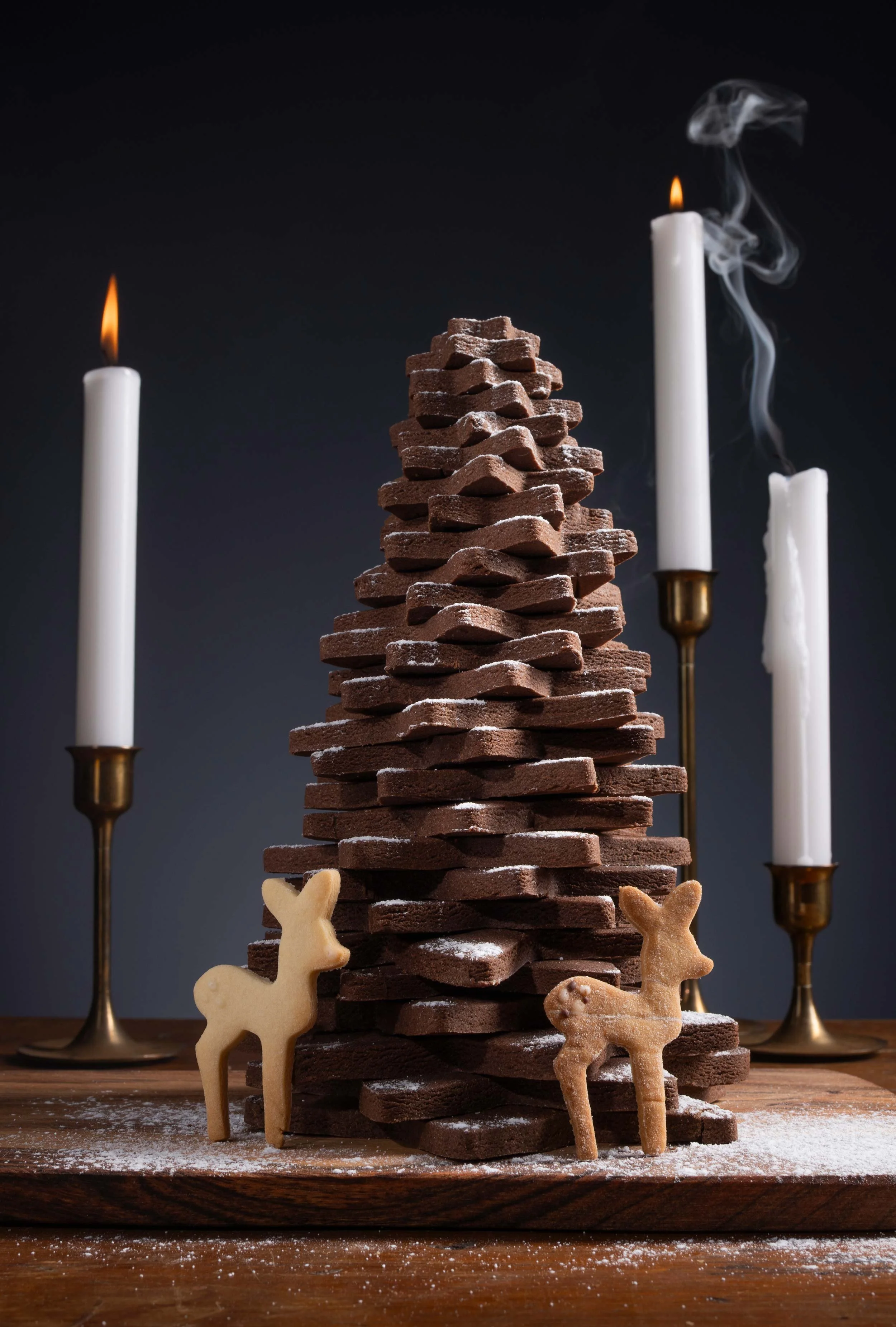 A festive Christmas tree crafted entirely from chocolate biscuits, stacked high in a deliciously edible tower and dusted with icing sugar “snow.” 