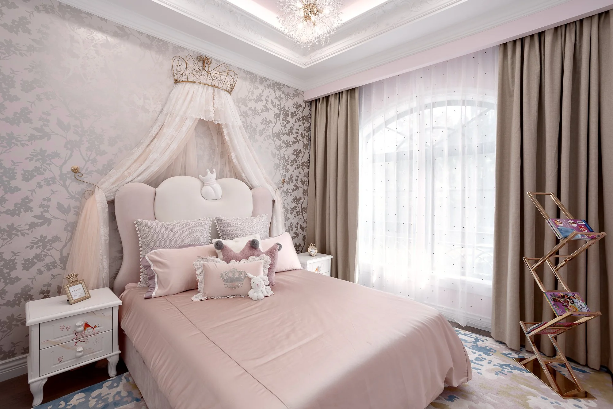 Whimsical girl's bedroom featuring a pink canopy bed, floral wallpaper, and soft lighting, reflecting the project’s bright and playful vision.