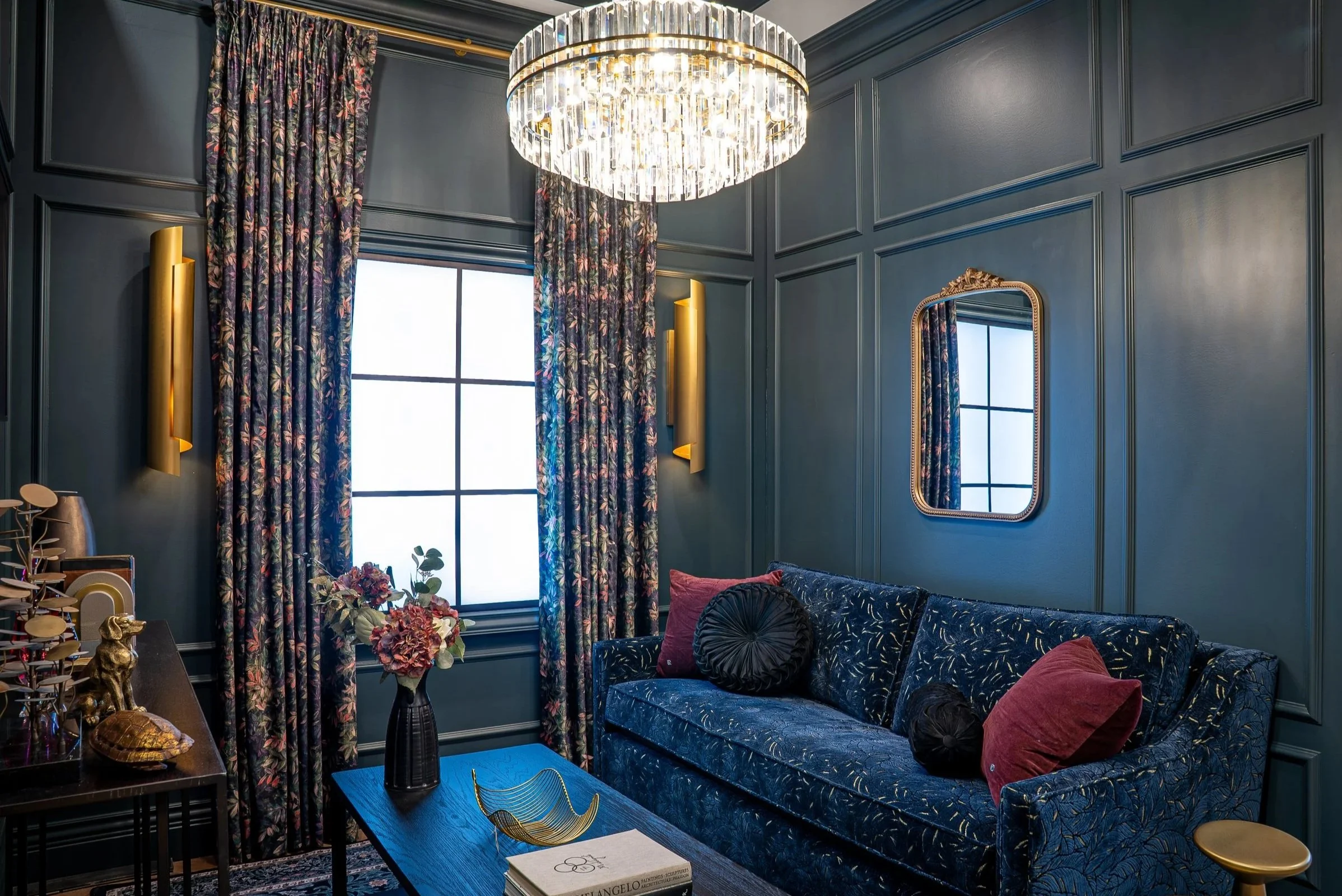 maximalism living room with velvet sofa and floral drapery