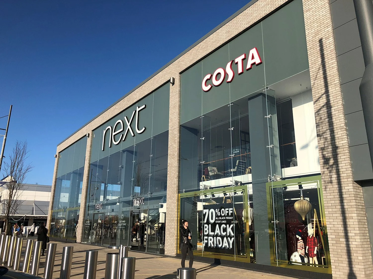 bright blue sky and large shopping retail park buildings