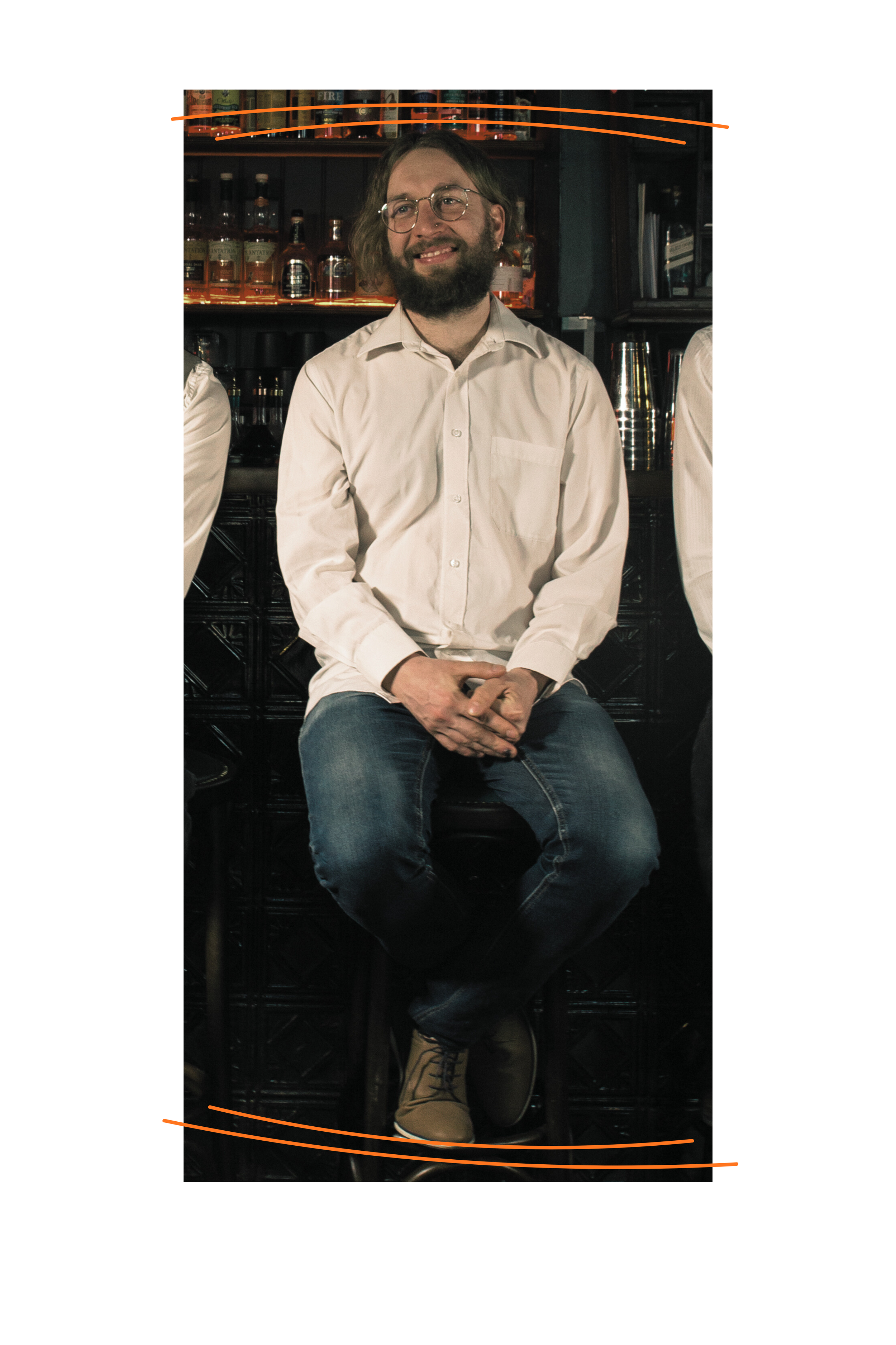 Barney, a white man with mid-length brown hair and a subtle smile, glasses, white shirt and jeans