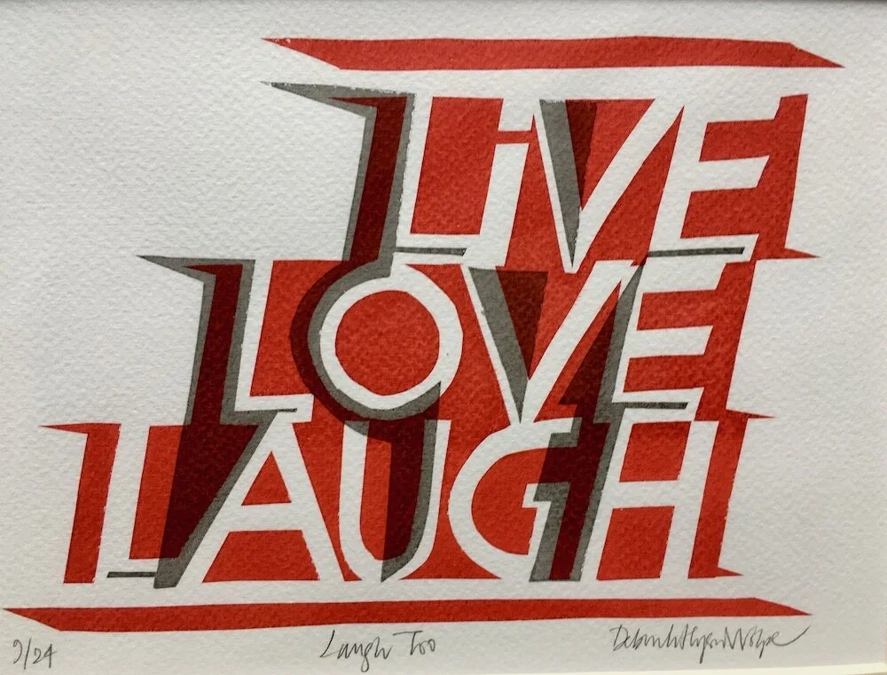 Typography art with the words "Live, Love, Laugh" arranged in a dynamic, layered style in red, white, and gray colors.