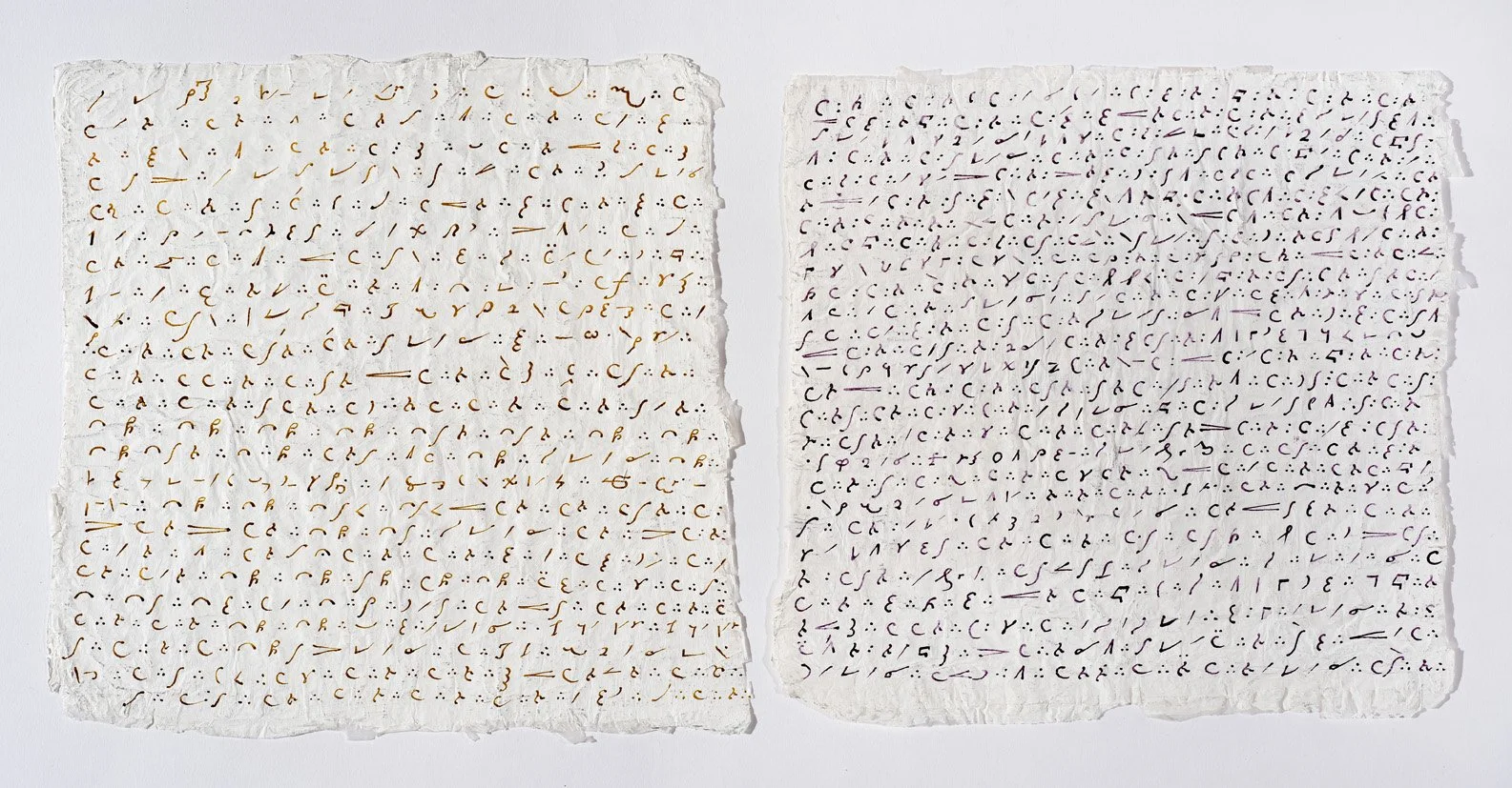 Two sheets of torn, textured paper with handwritten text in different colors. The left sheet has orange writing, and the right sheet has purple writing.