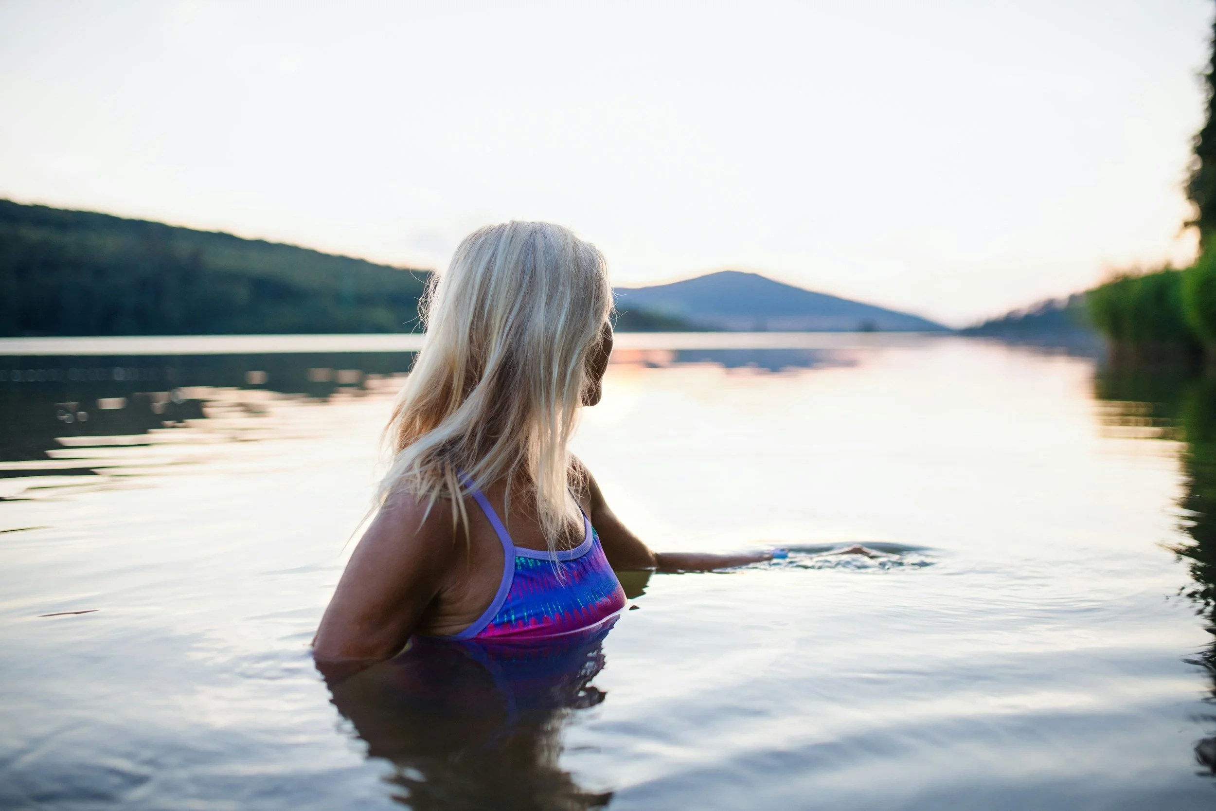 woman in infinity pool looking out in distance