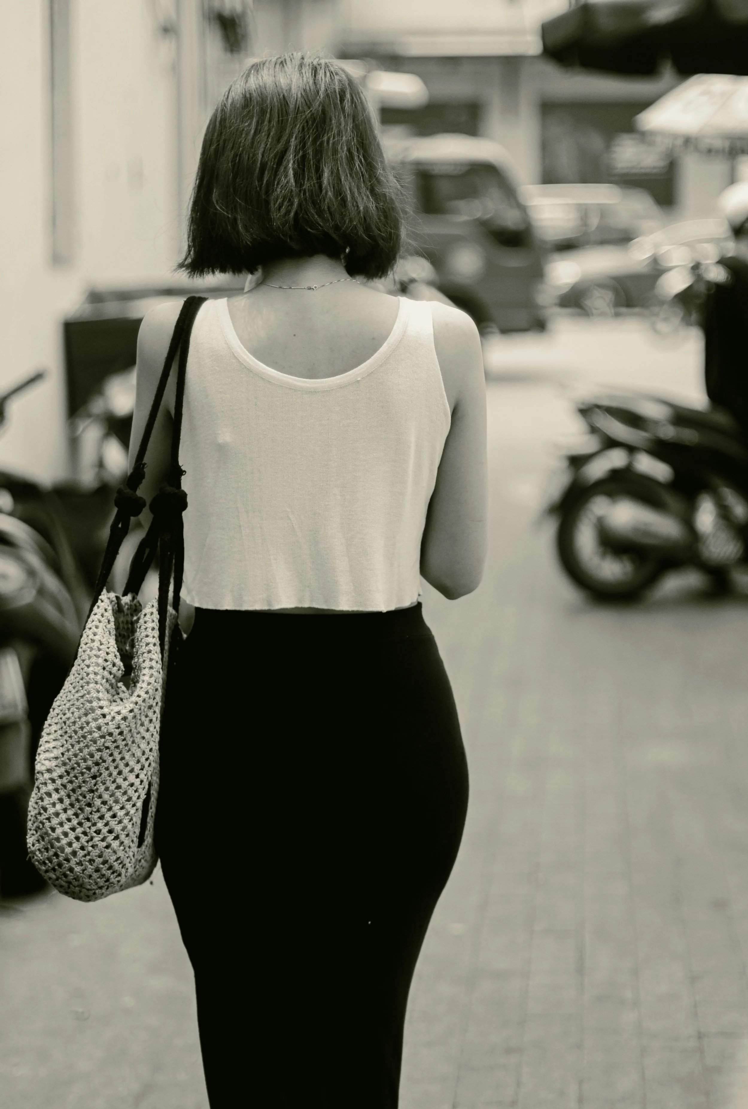 woman walking black and white