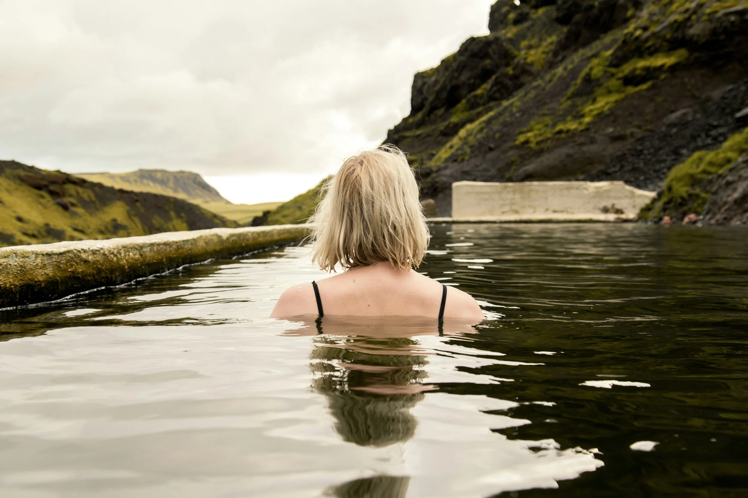 rear view of woman in pool in nature